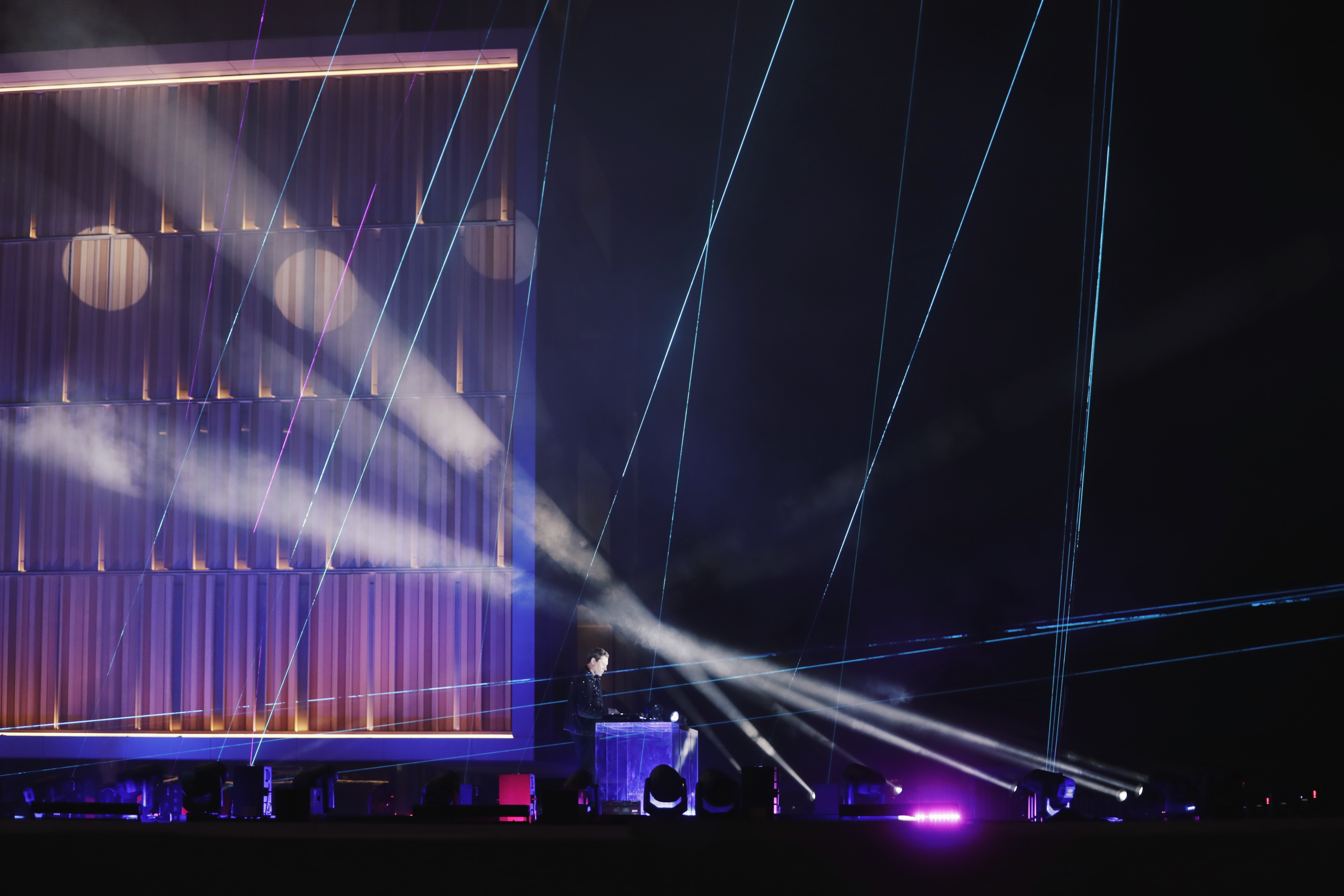 White and violet laser beams across the hotel facade set, Tiesto & Tate McRae Music Clip Dubai
