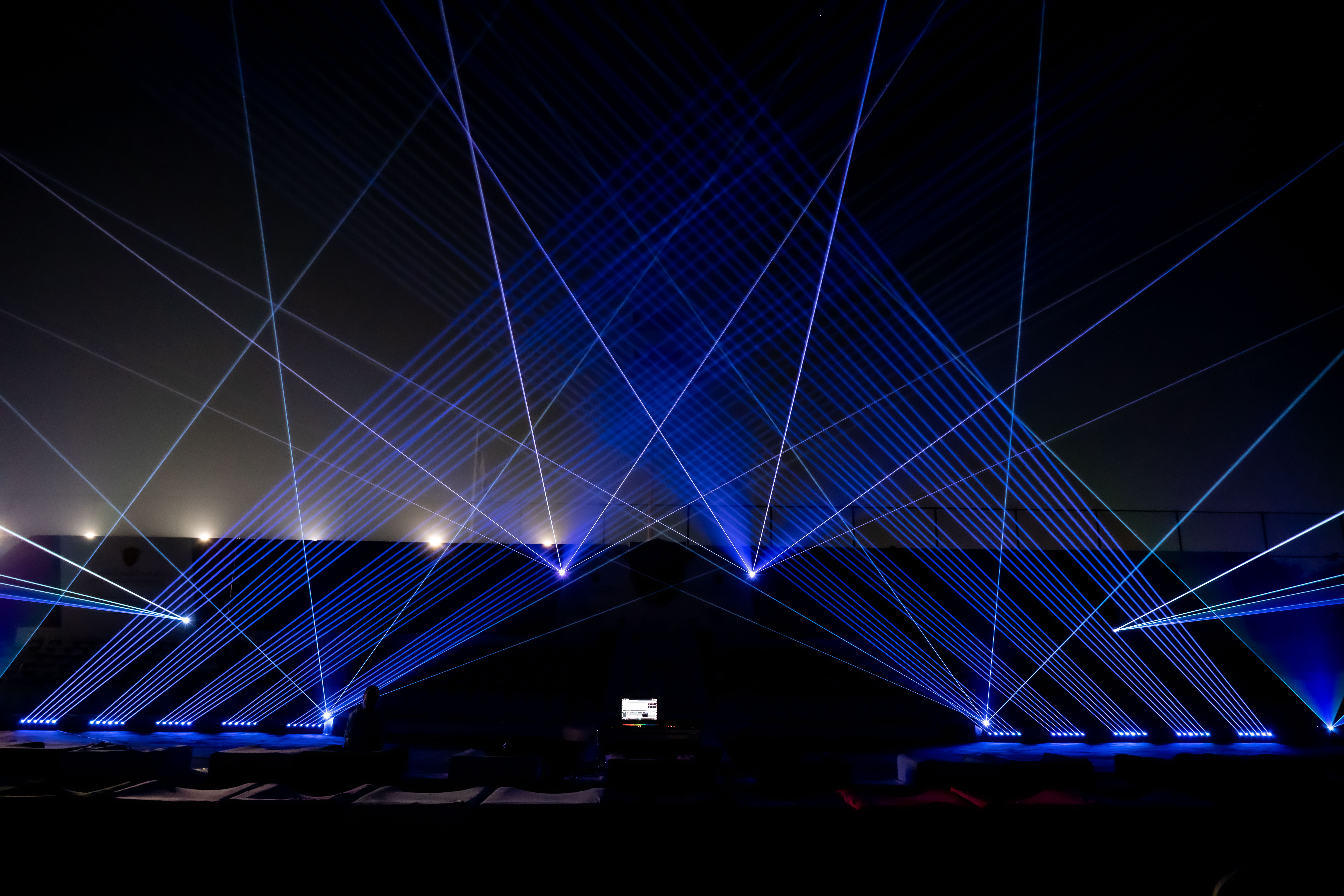 Blue laser beams over the graduation venue at night, Thumbay Gulf Medical University Graduation, Sharjah, UAE