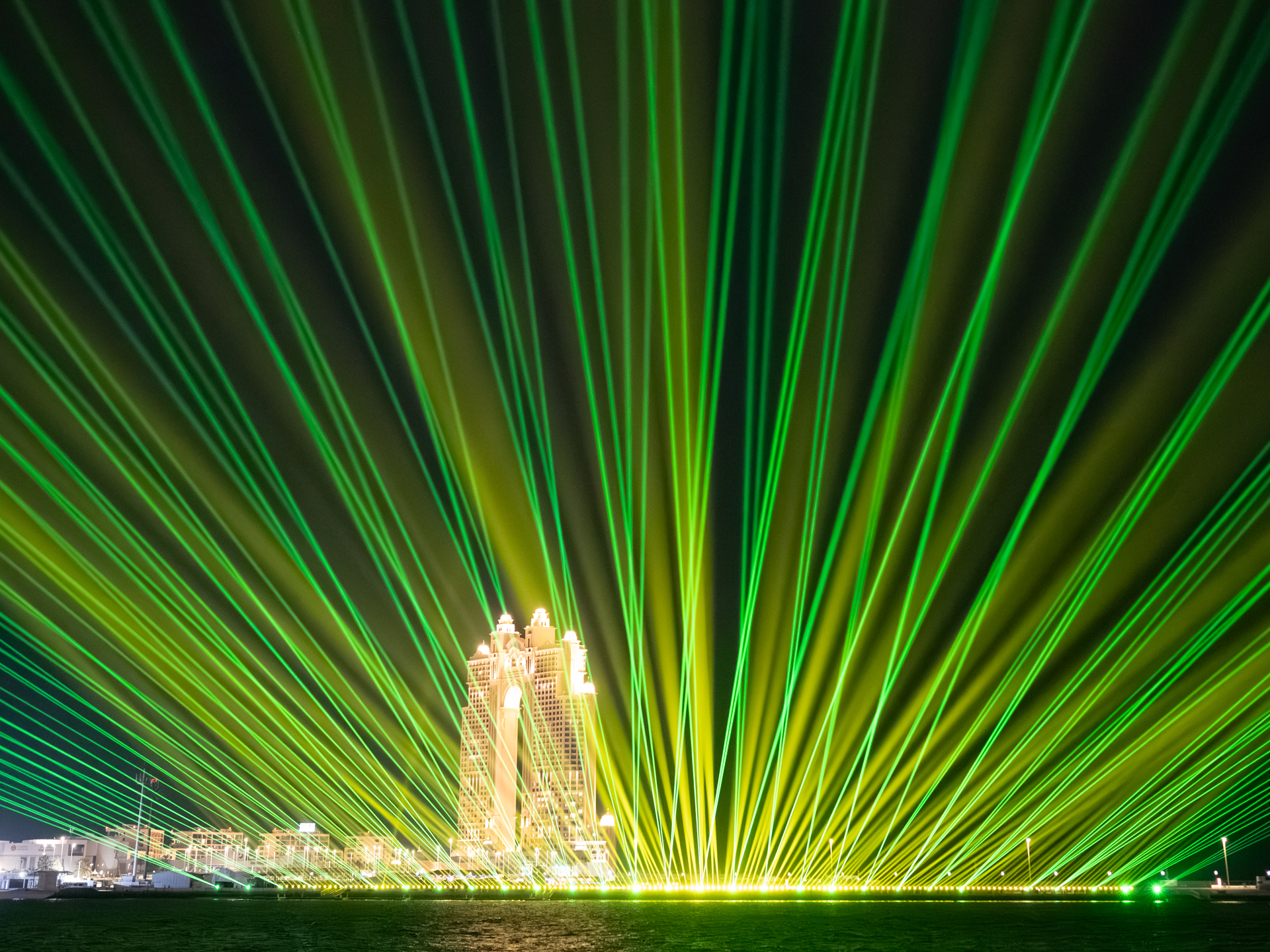 Green and gold laser fans over the waterfront, Eid Al Fitr At Abu Dhabi Corniche