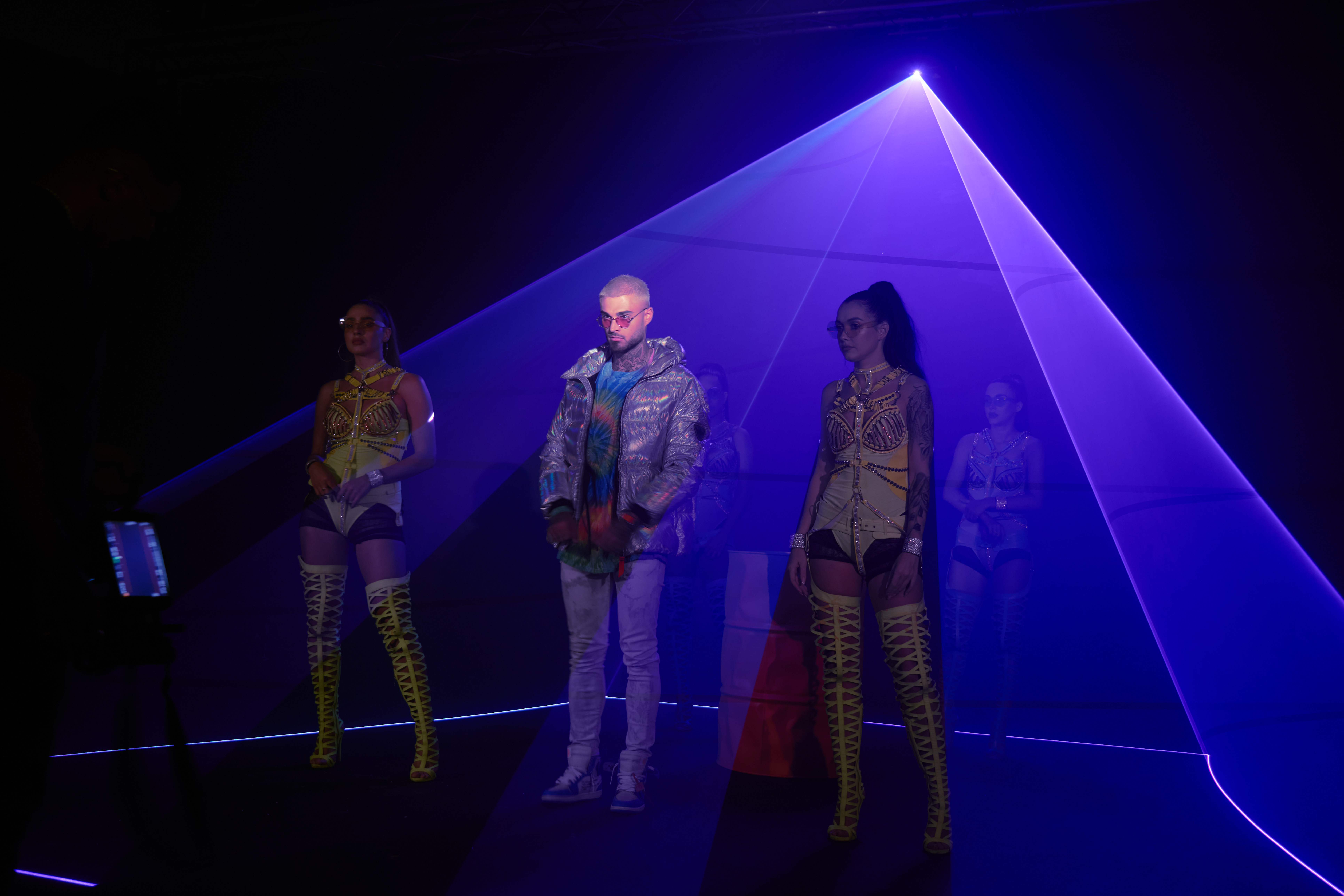 Artists posing inside a blue laser pyramid, Candela T Garcia Video Clip, UAE