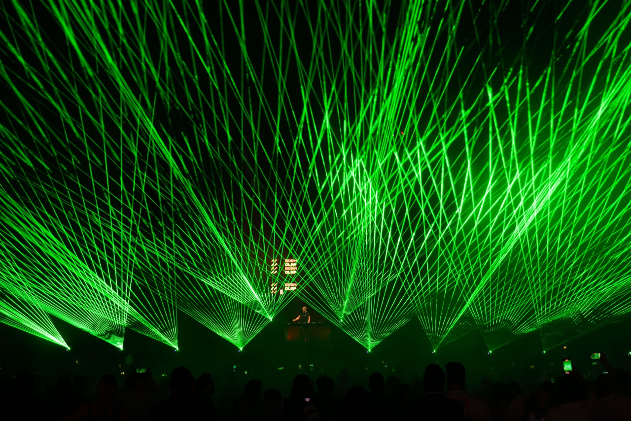Green laser canopy over a New Year's Eve crowd