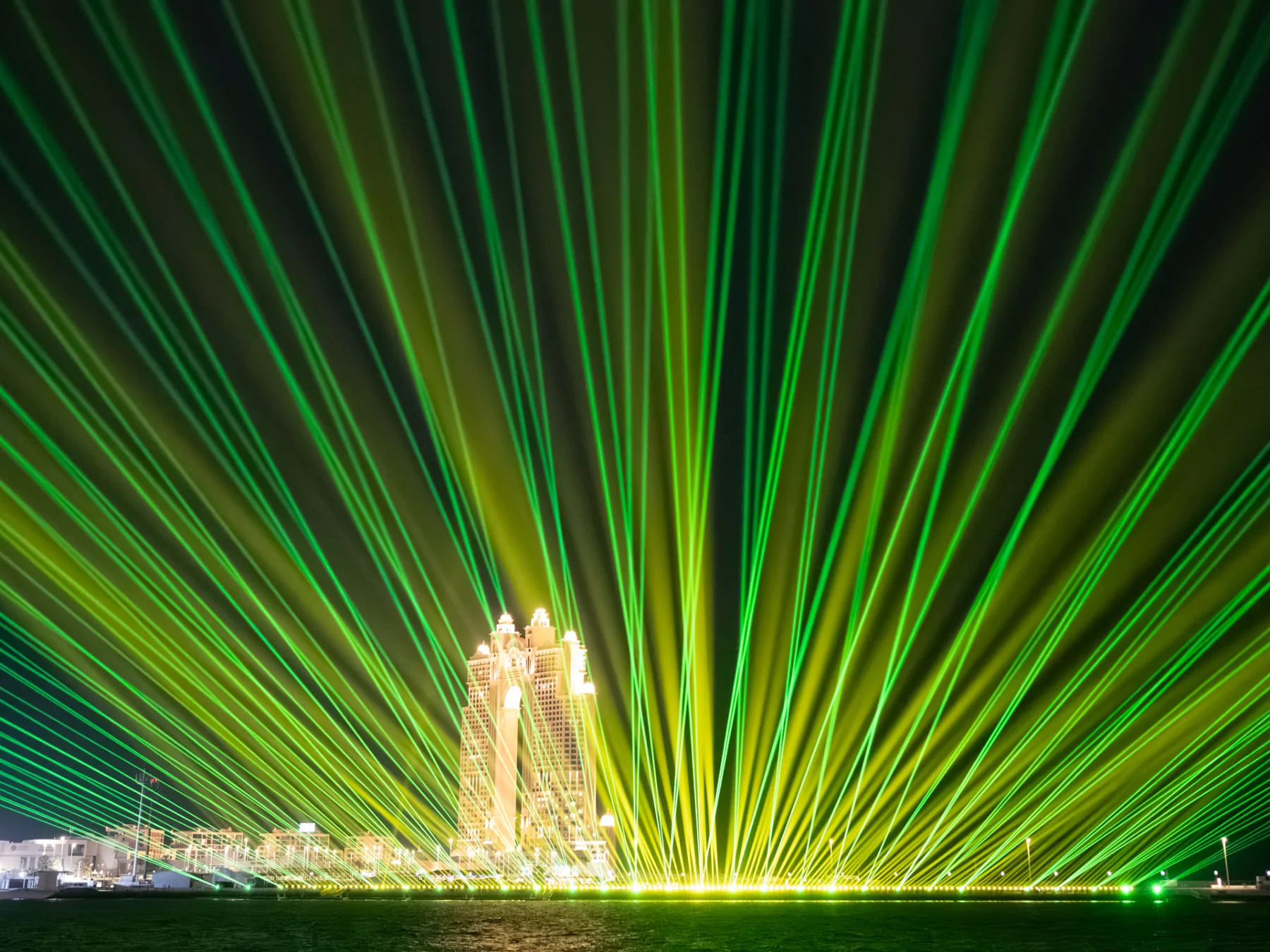 Green and gold laser fans over the waterfront, Eid Al Fitr At Abu Dhabi Corniche