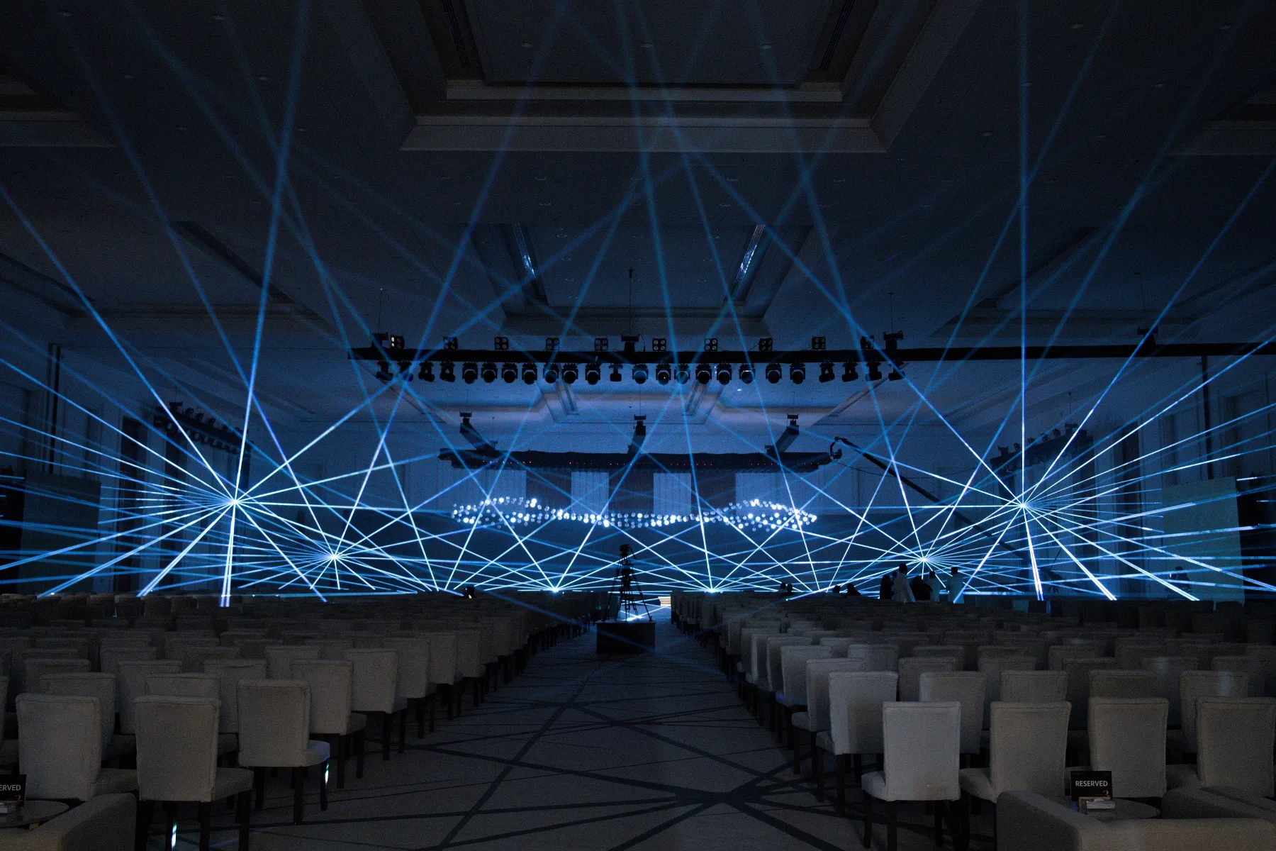 Cyan laser beams over the ballroom stage, ROSHN Anniversary KSA