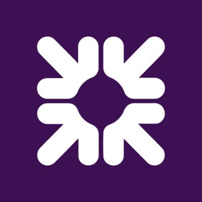 Four white arrows pointing inward forming a square on a dark purple background.