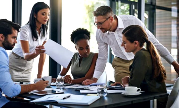 Ethnically diverse image of male and female accounting staff meeting.