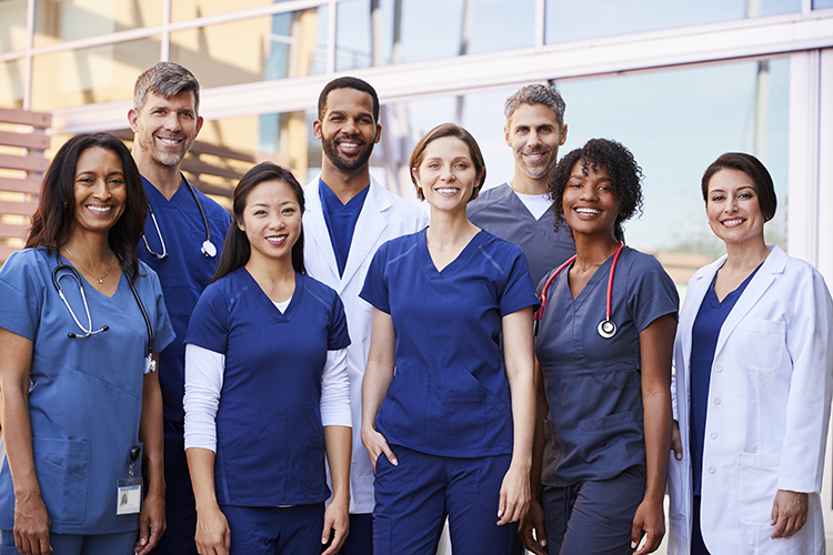 Group of ethnically diverse physicians in front of emergency room.