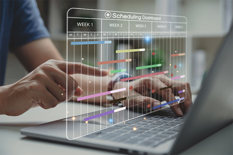 Composited image of male physician hands pointing to a scheduling dashboard hovering above his laptop.