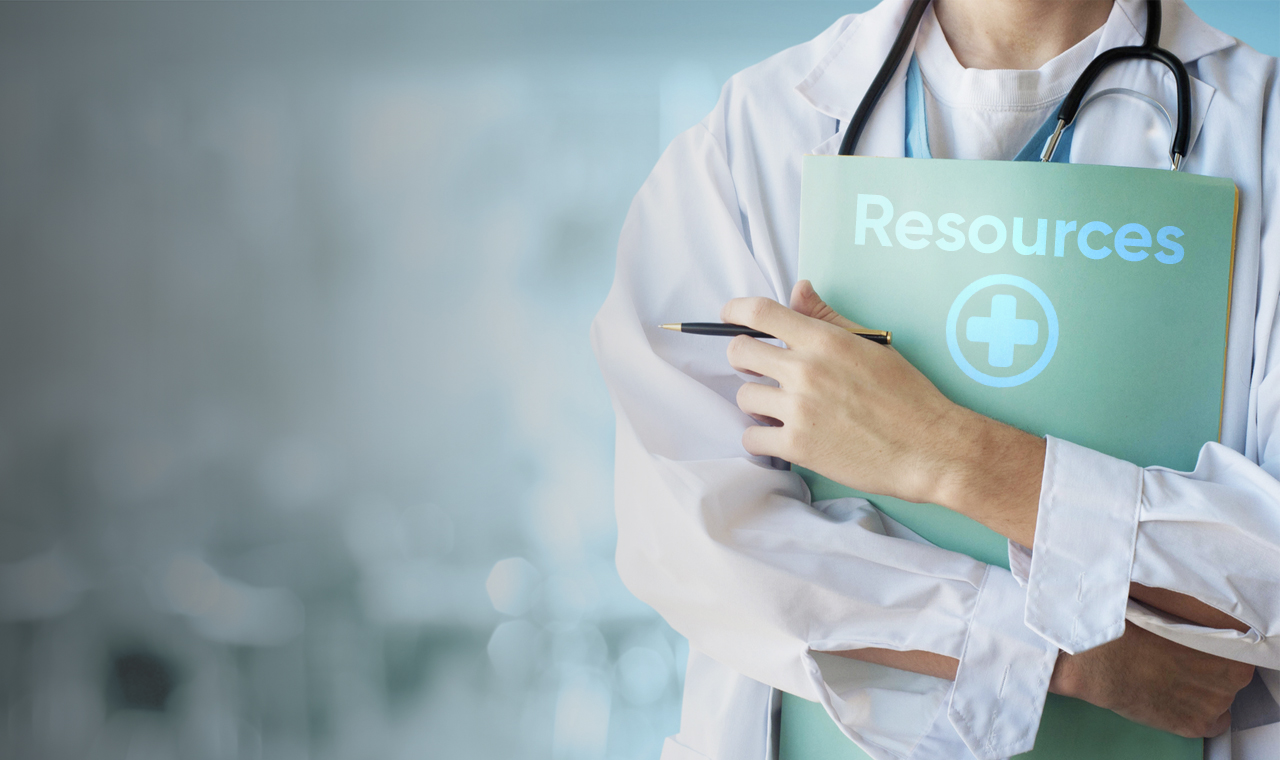 A female physician holding a document entitled resources.