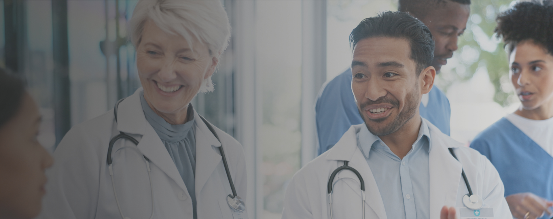 A female physician smiling at group of multi-ethnic doctors.