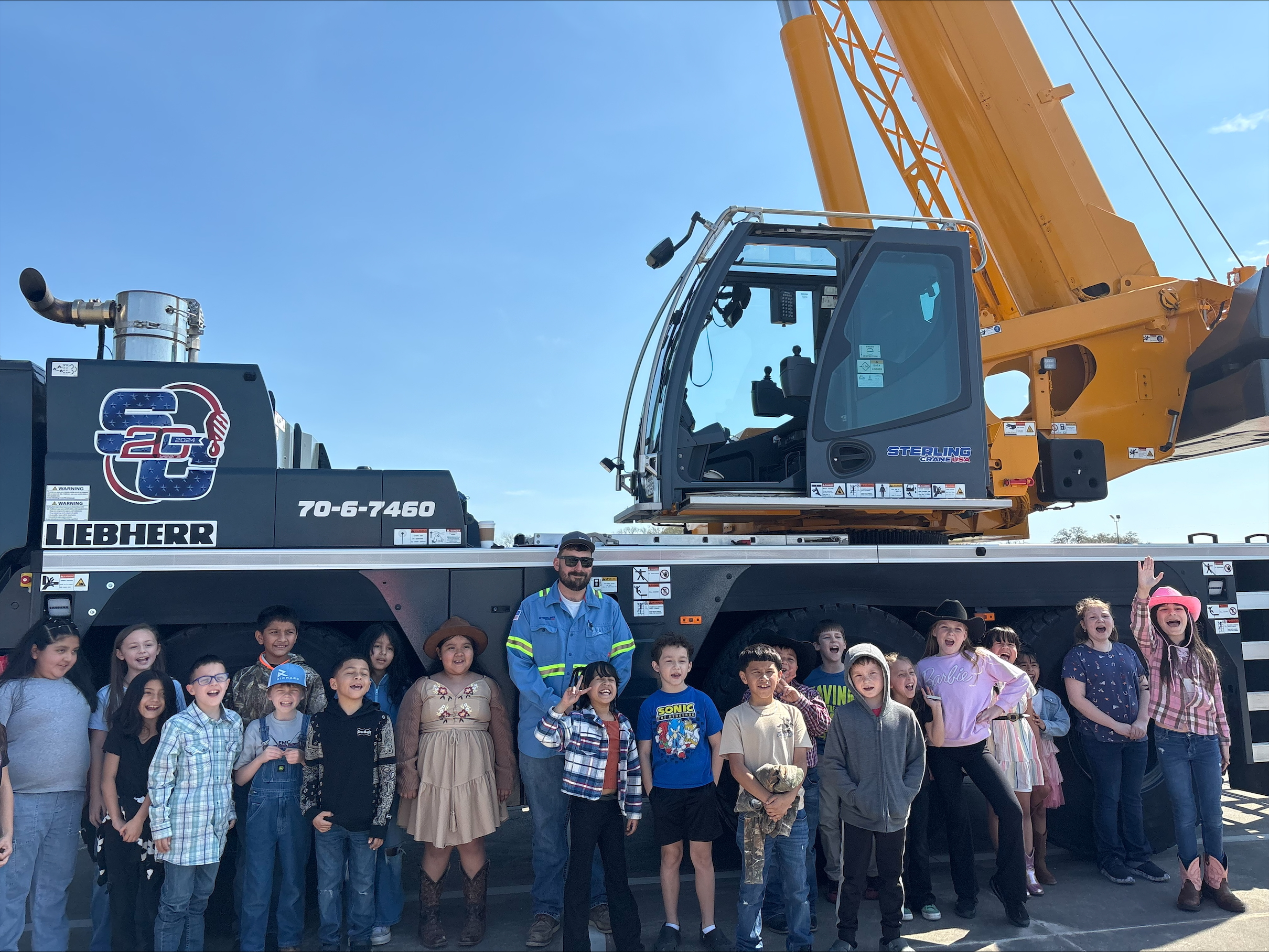 A photo of a group of children participating in the Touch-A-Truck event
