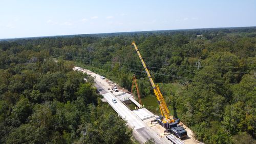Sterling Crane USA lifting precast concrete beams during a bridge construction project in southern Texas.