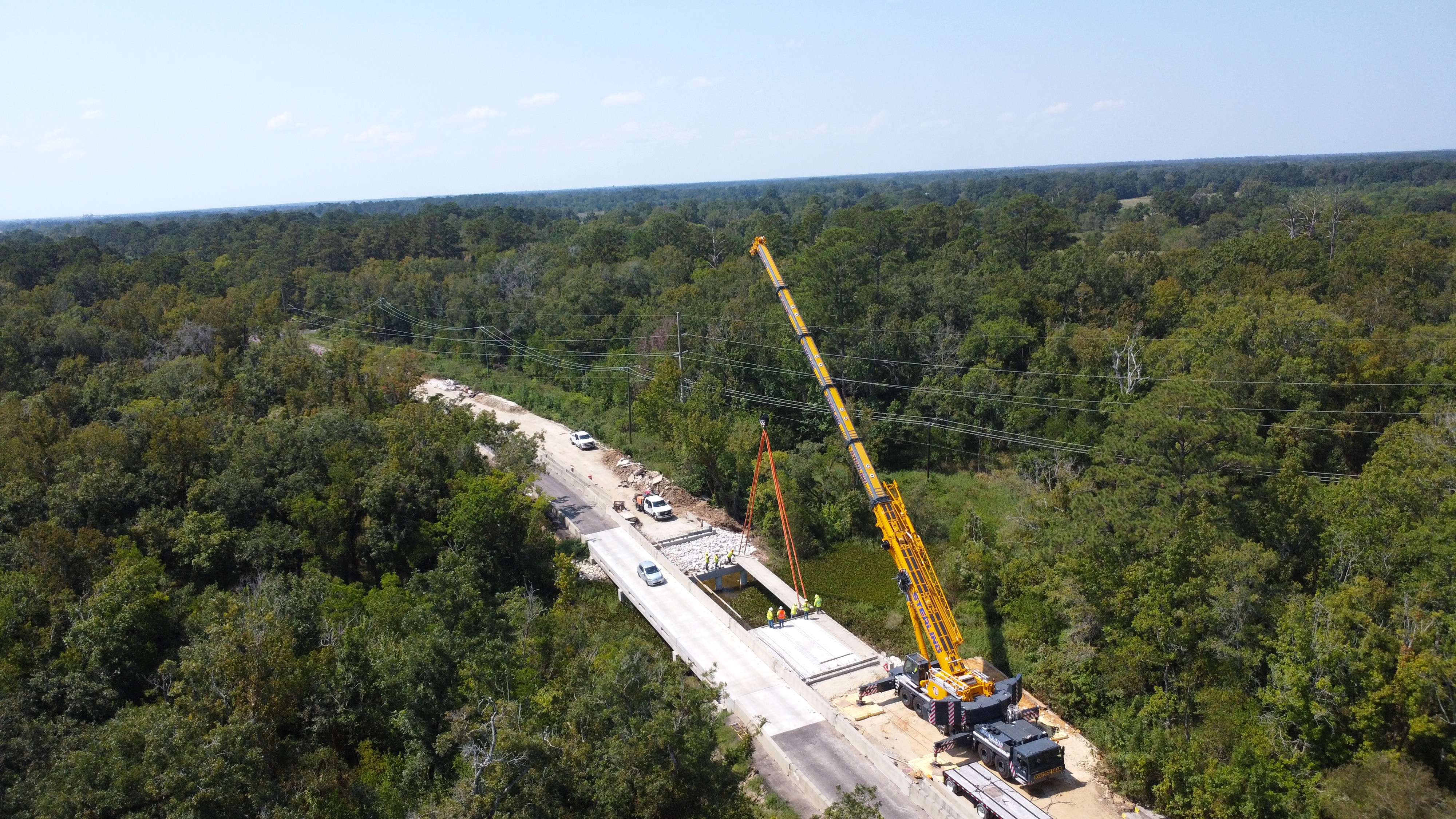 Sterling Crane USA lifting precast concrete beams during a bridge construction project in southern Texas.