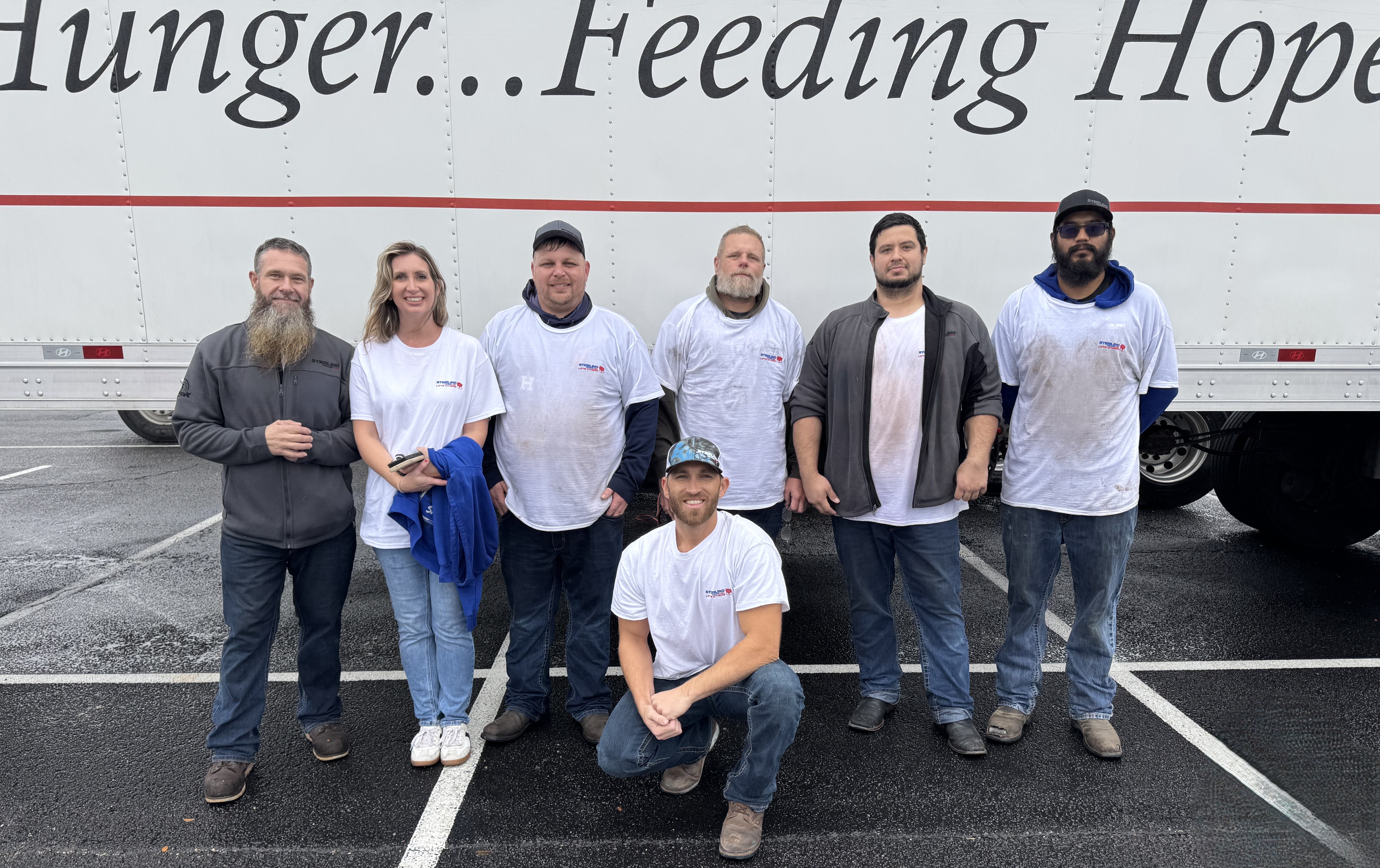 Sterling Crane USA Pleasanton branch volunteers supporting San Antonio families at a San Antonio Food Bank holiday food distribution event.