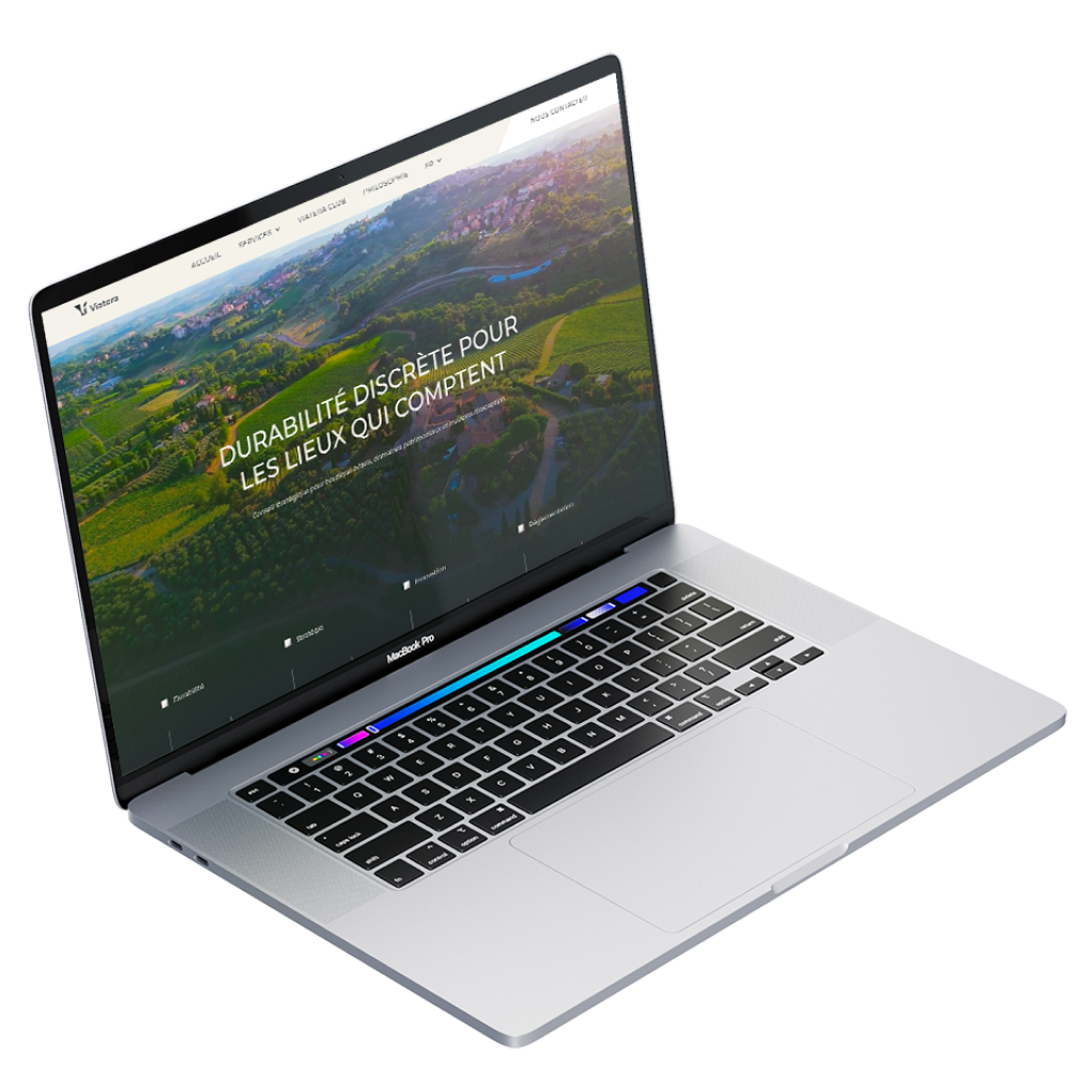 Ordinateur portable MacBook Pro affichant un site web avec le texte principal « De l’aspiration à la réalisation » sur fond bleu avec des éléments graphiques floraux jaunes et blancs.