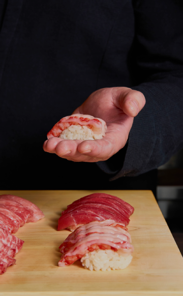 Alba chef shaping nigiri at the Omakase Counter