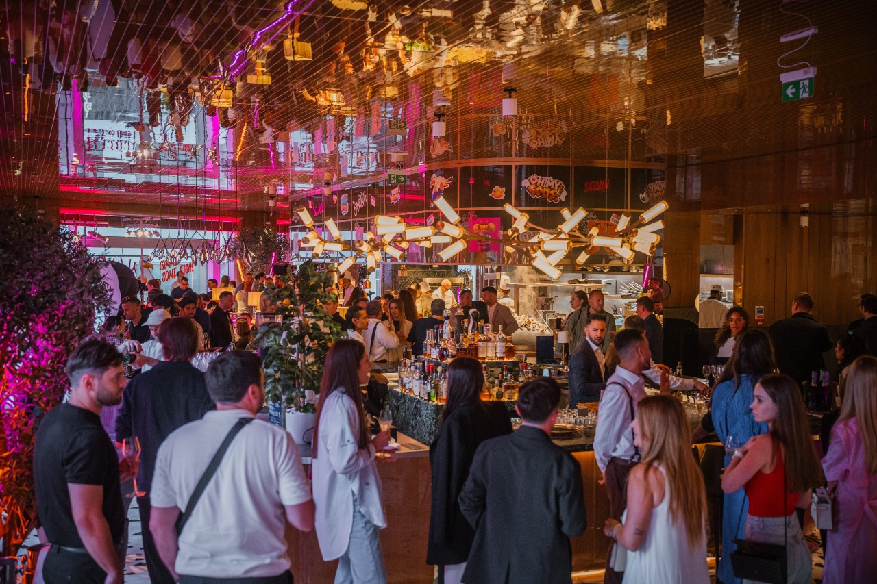 Guests enjoying a lively private evening event at ALBA London's bar
