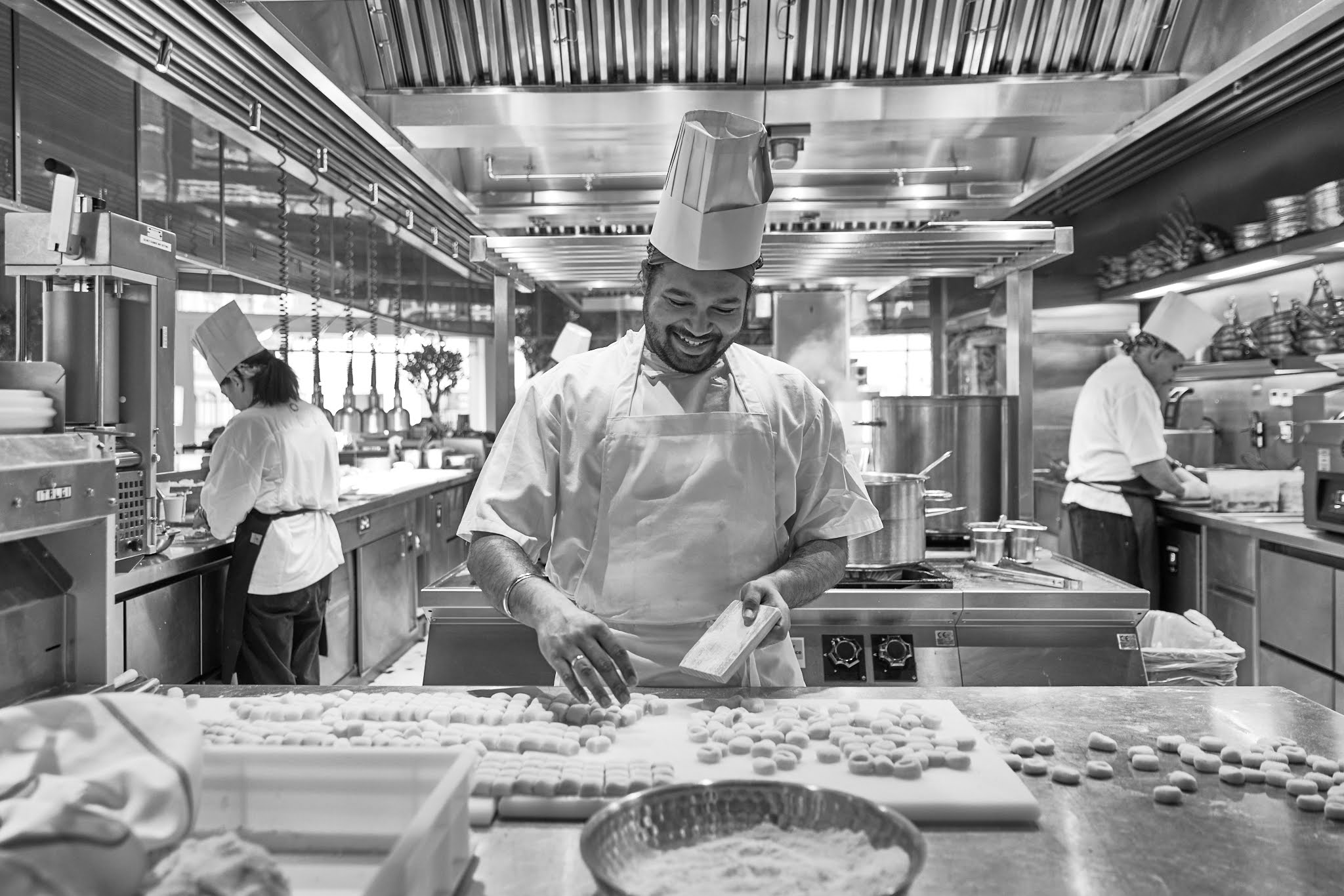 Chef shaping fresh pasta by hand in the kitchen at ALBA London