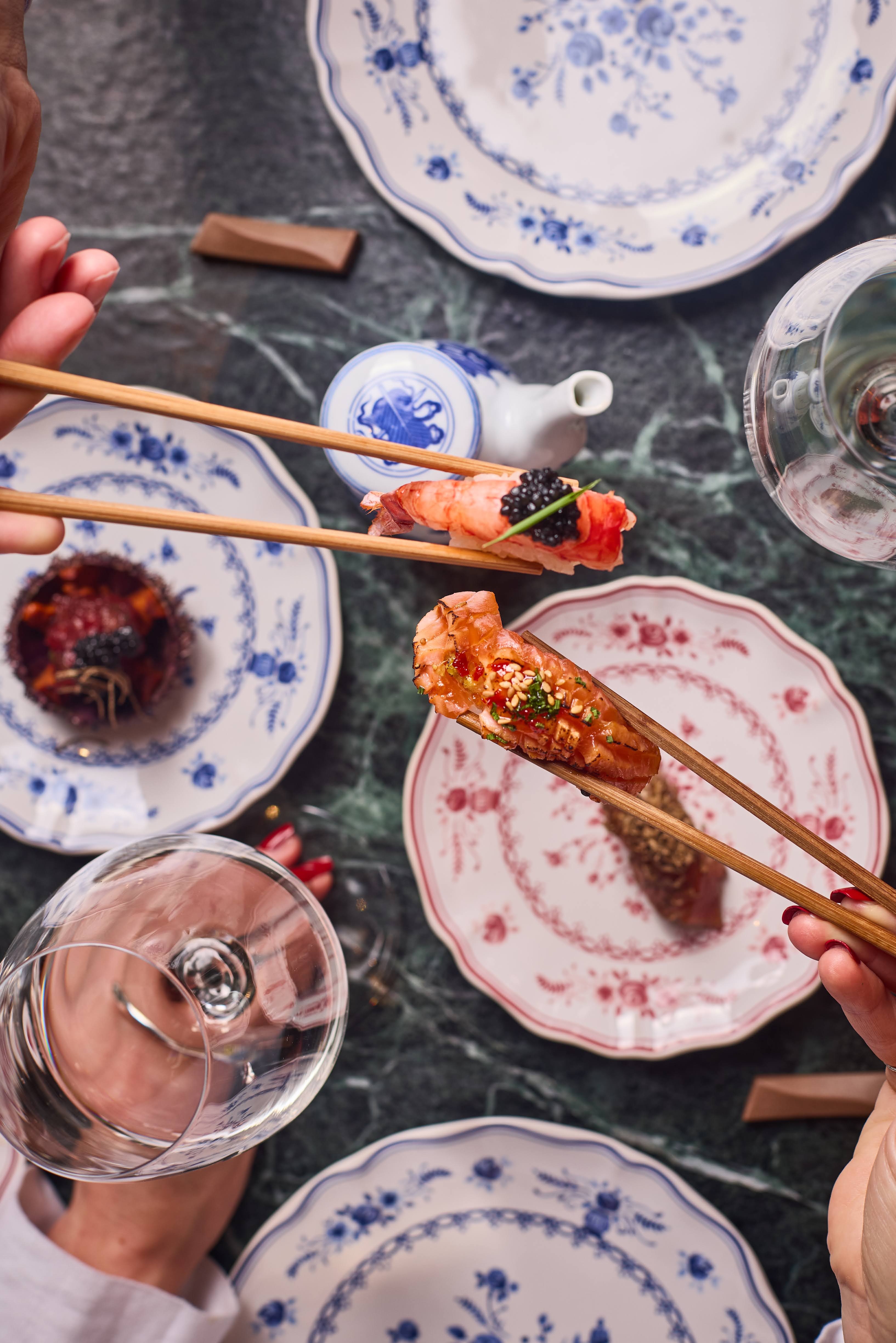 Chefs preparing dishes at the ALBA sushi counter