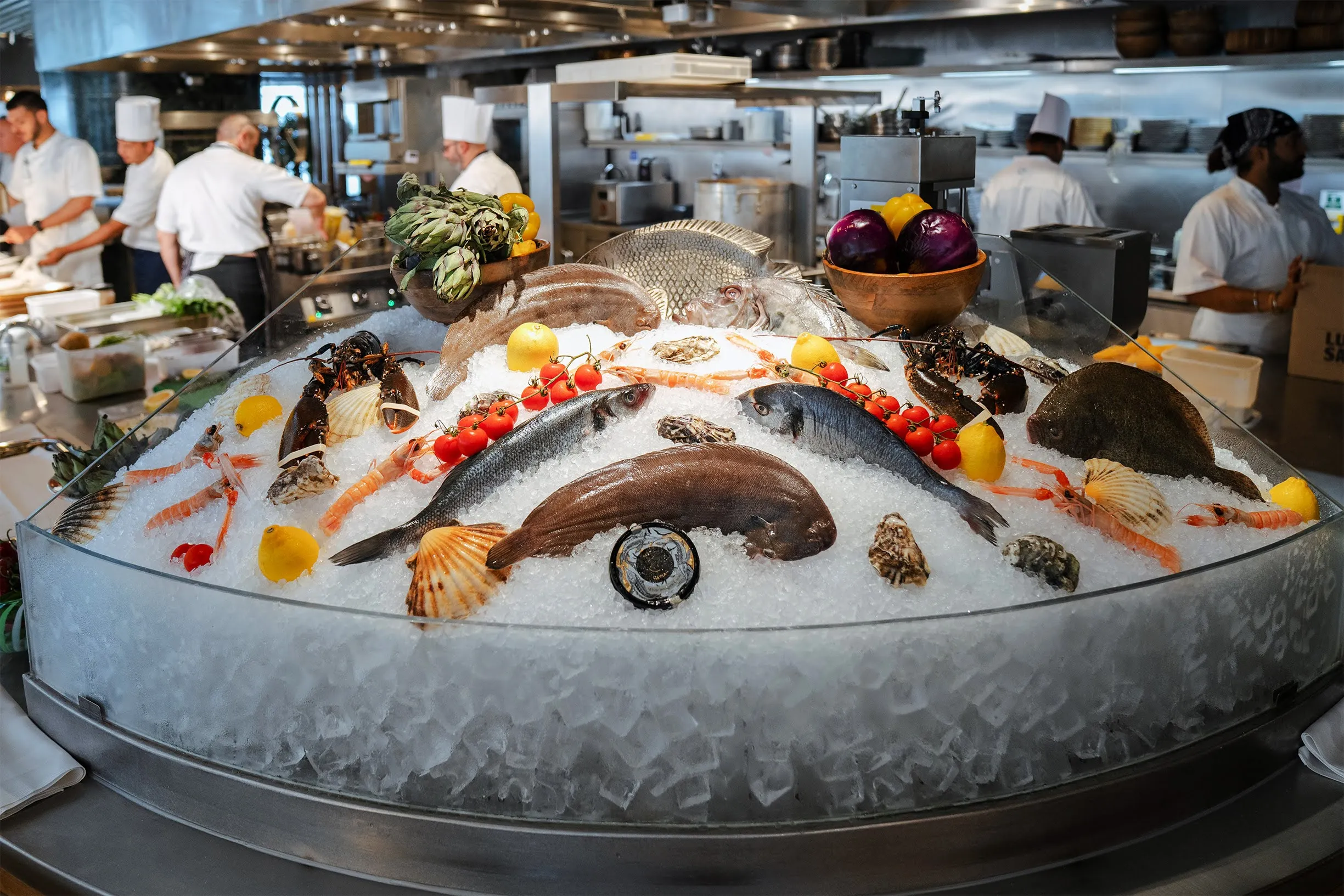 Fresh fish and shellfish display on ice at ALBA London's open kitchen