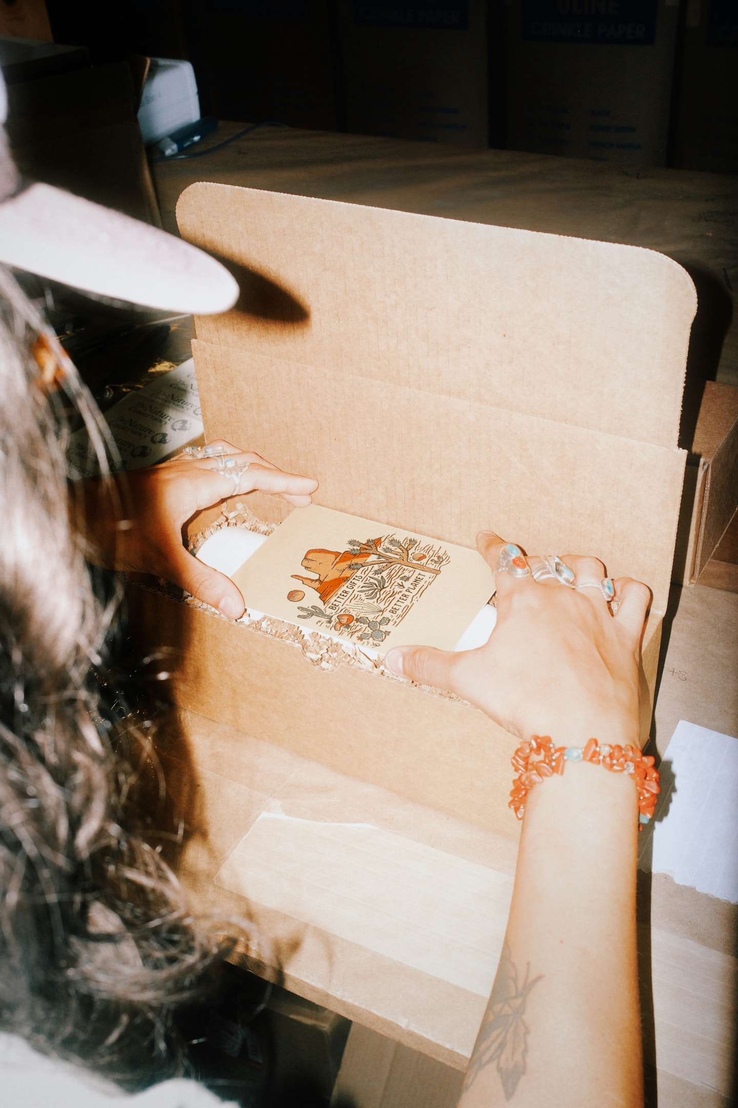 A product-based business owner packing an order from their home on the Saltbox Starter Plan.
