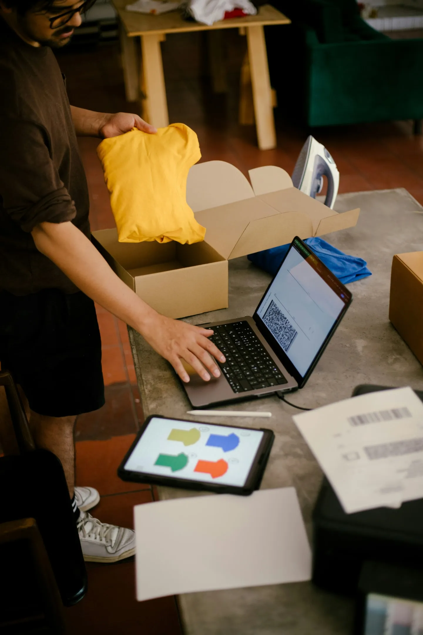 A small business owner packing orders from their workspace.