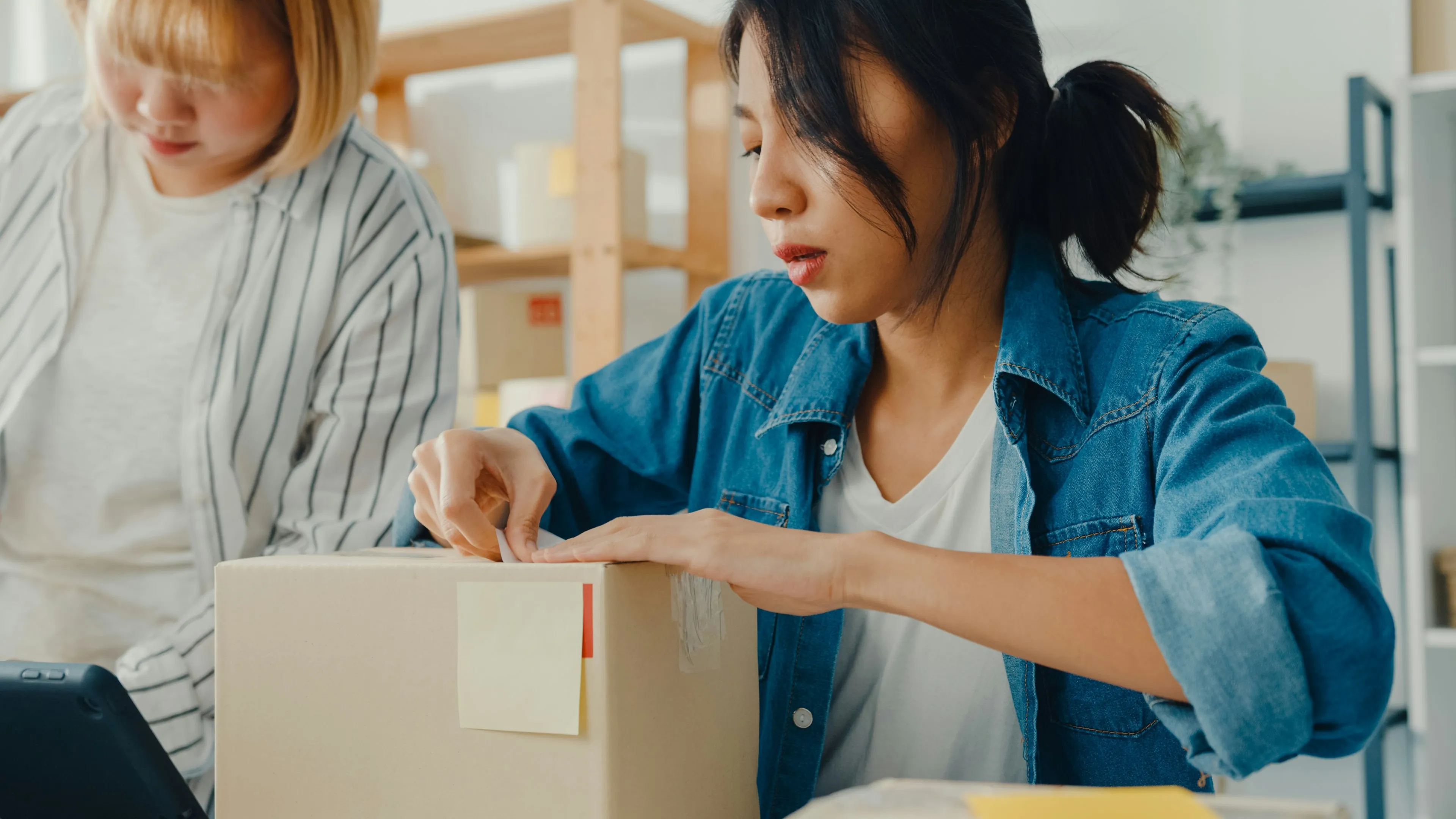 An organized small ecommerce workspace with dedicated zones for receiving, packing, and inventory management, illustrating a scalable home fulfillment setup for growing online businesses.