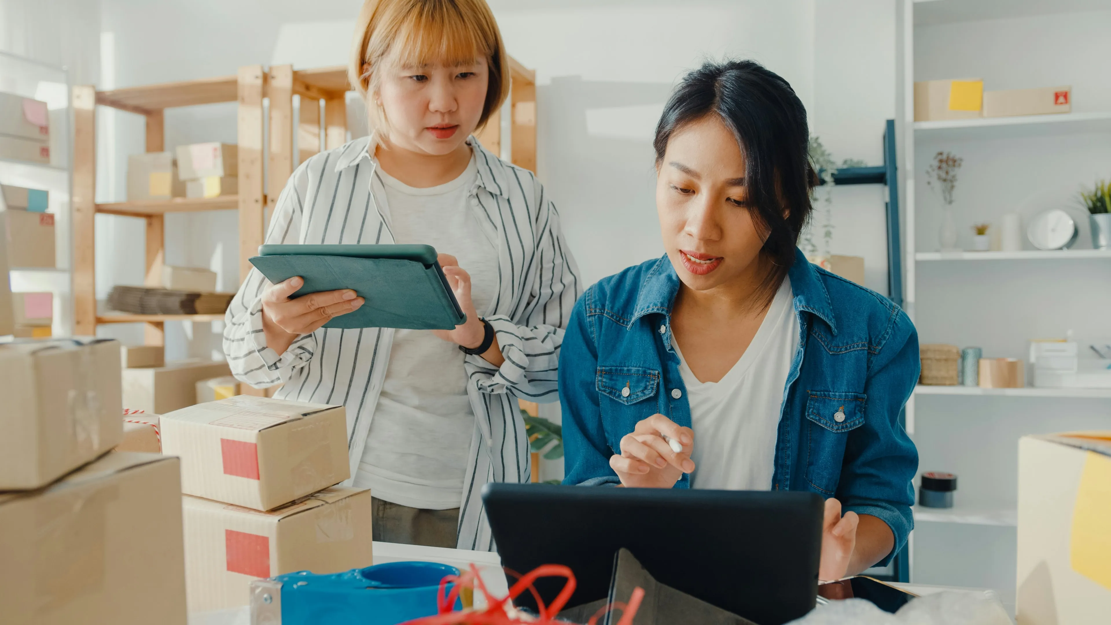 Small business using technology to streamline logistics operations with efficient inventory management and shipping process.
