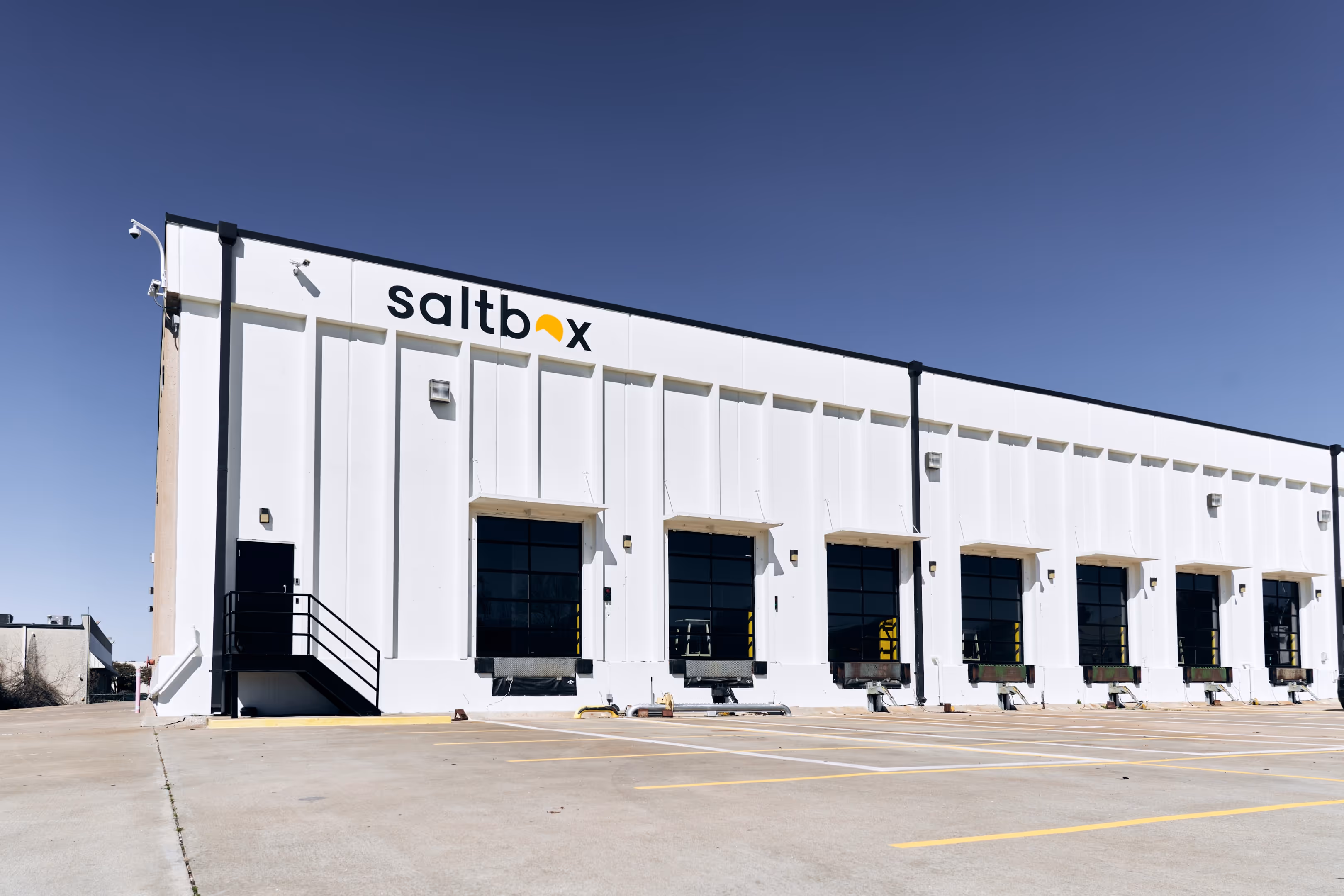 A Saltbox warehouse building with multiple loading bays, illustrating flexible warehouse access options for growing businesses without full lease commitments.