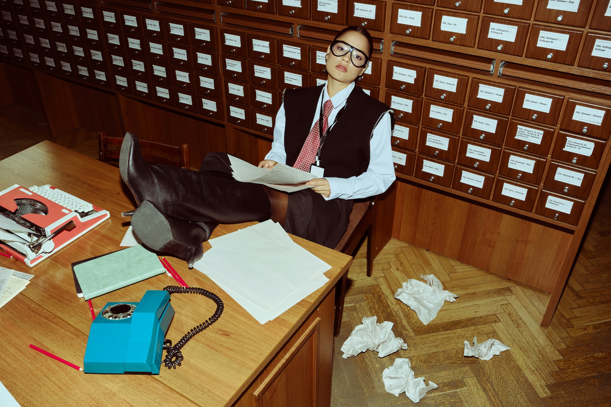 A frustrated entrepreneur tries sits at a desk trying to navigate several small business challenges.