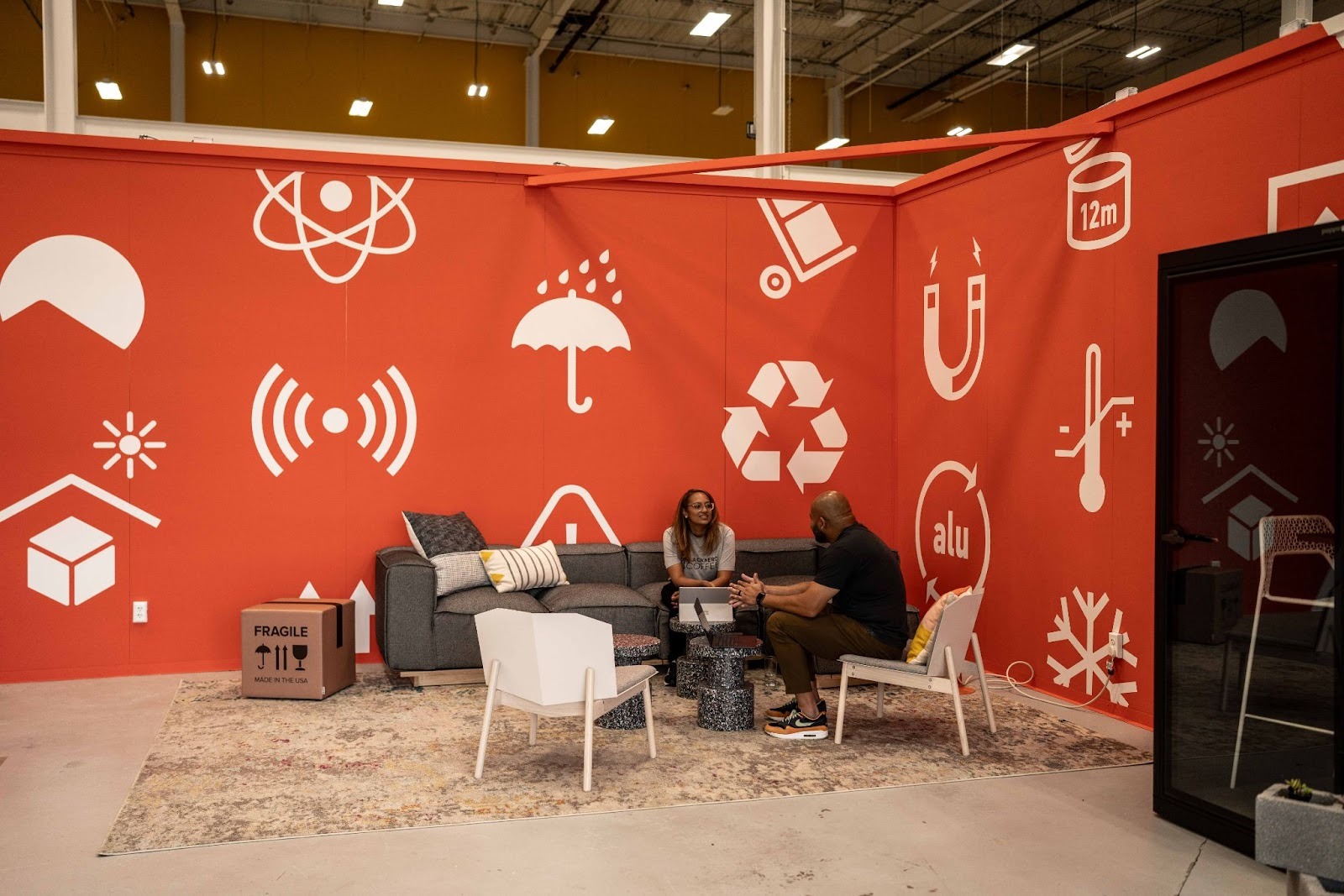 Two owners interact in the co-warehousing collaboration space within the facility.