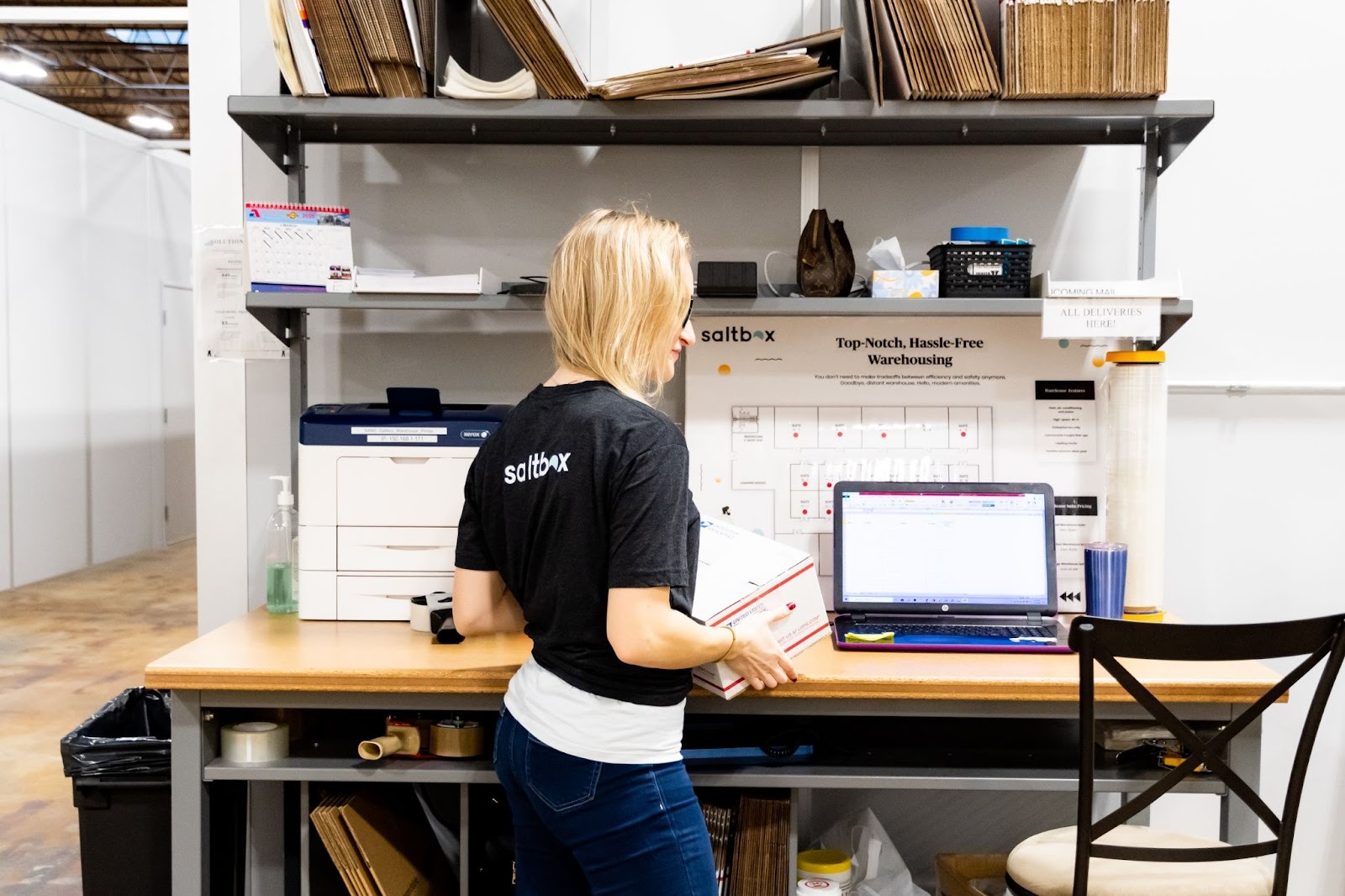 An owner moves between her co-warehousing space and office space as she prepares her peak season marketing plan.