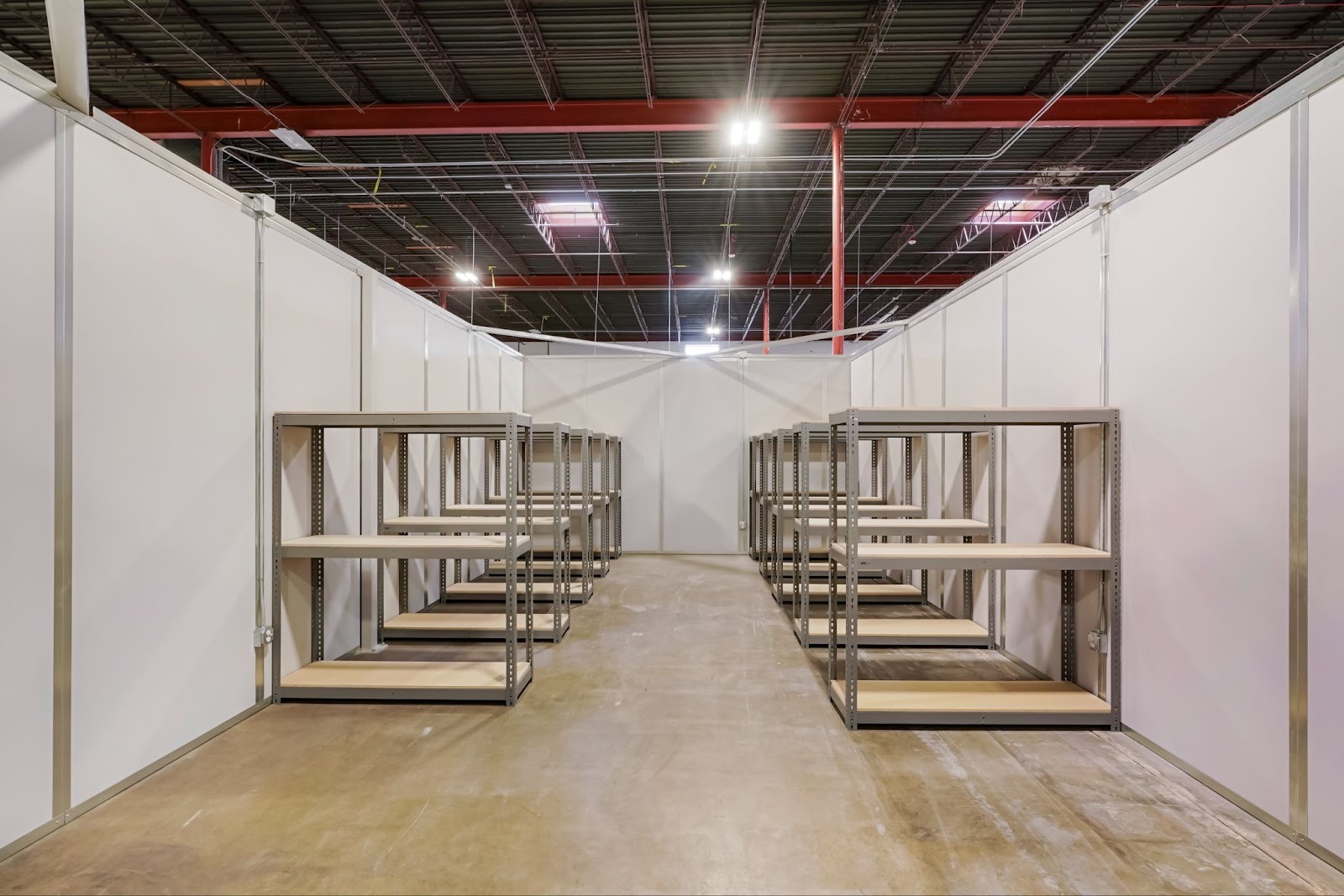 Rows of small containers placed  in a small bay area as a owner determines how to set up a warehouse environment for their company.