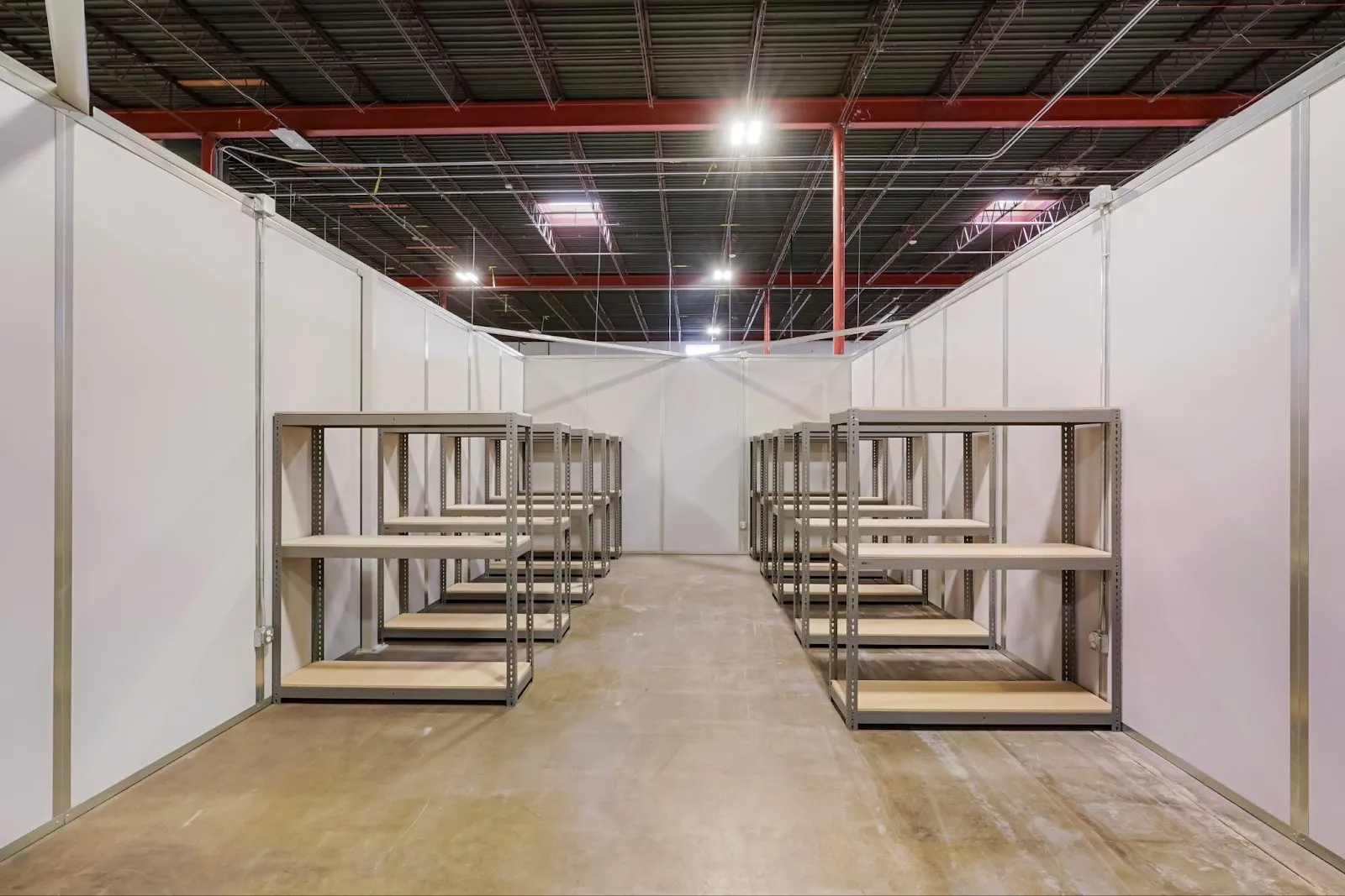 Rows of small containers placed  in a small bay area as a owner determines how to set up a warehouse environment for their company.