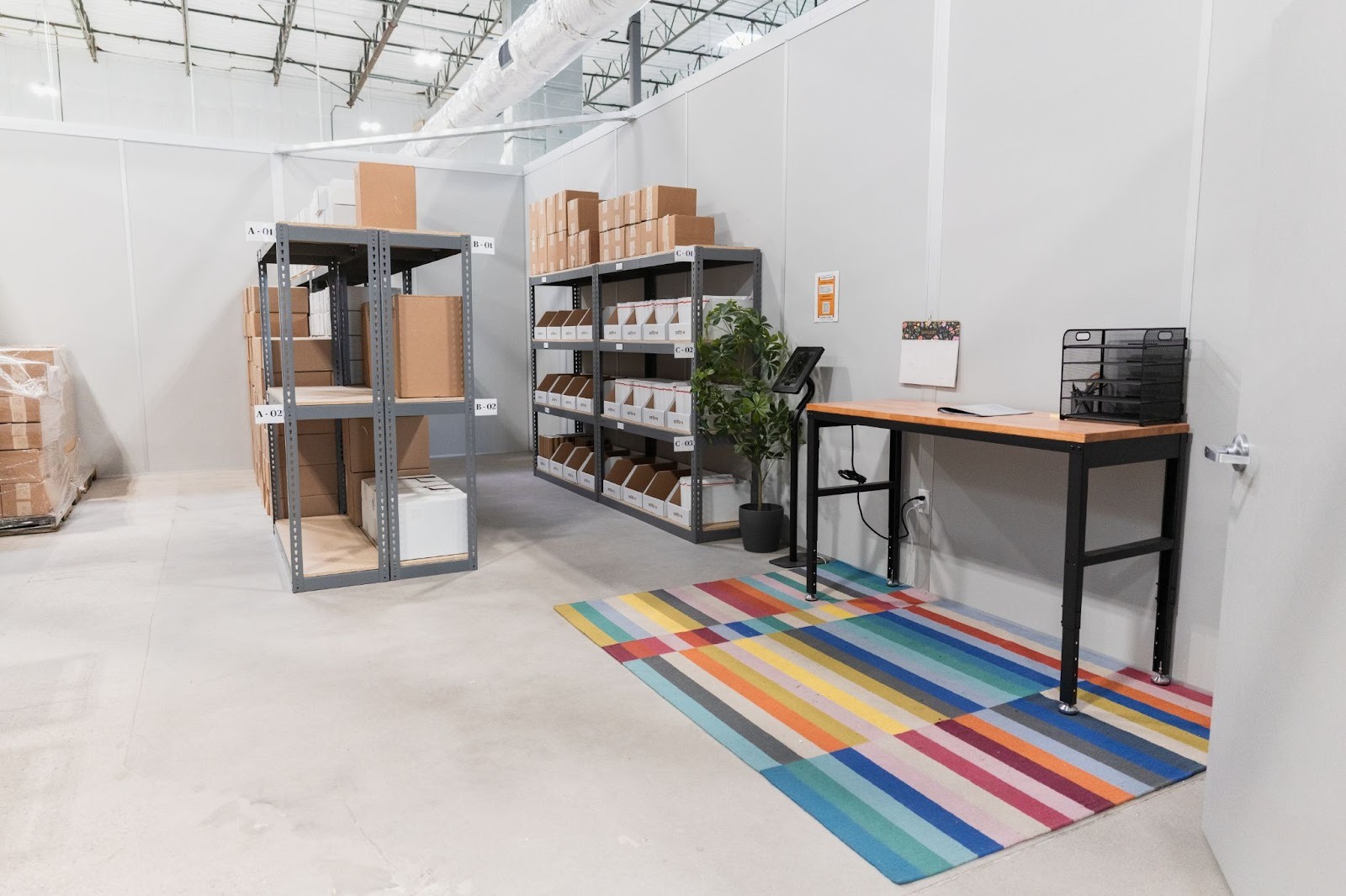 A laid out space with several designated areas created by an entrepreneur whose deciding how to set up a warehouse.