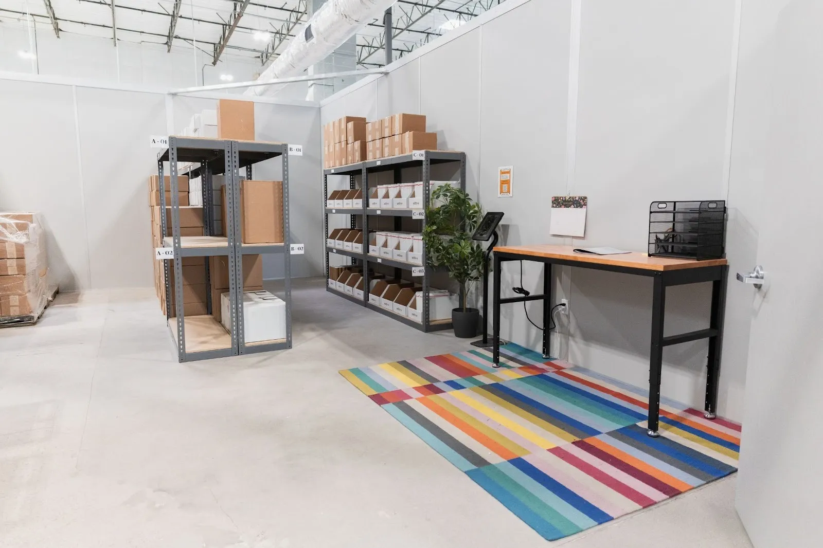 A laid out space with several designated areas created by an entrepreneur whose deciding how to set up a warehouse.