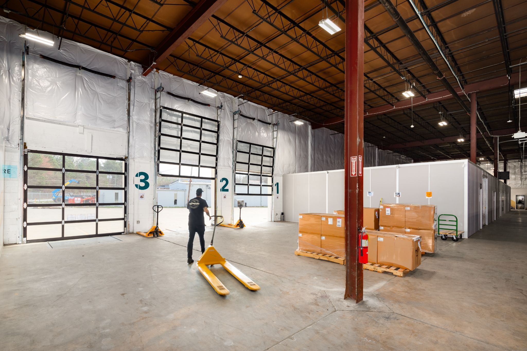 Worker walks through dedicated zones to move product as a strategy to reduce warehouses costs and improve pick-and-pack efficiency.