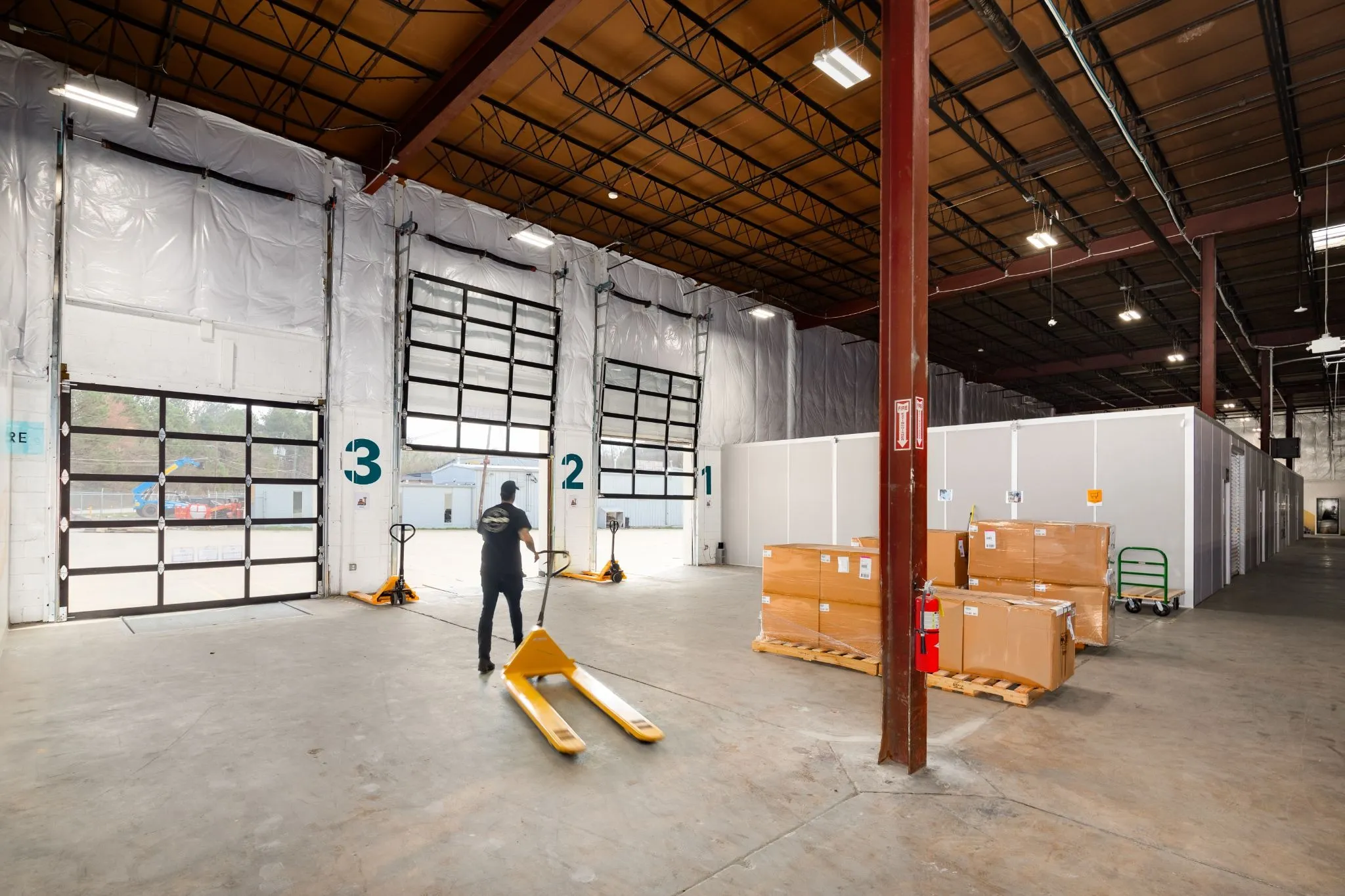 Worker walks through dedicated zones to move product as a strategy to reduce warehouses costs and improve pick-and-pack efficiency.