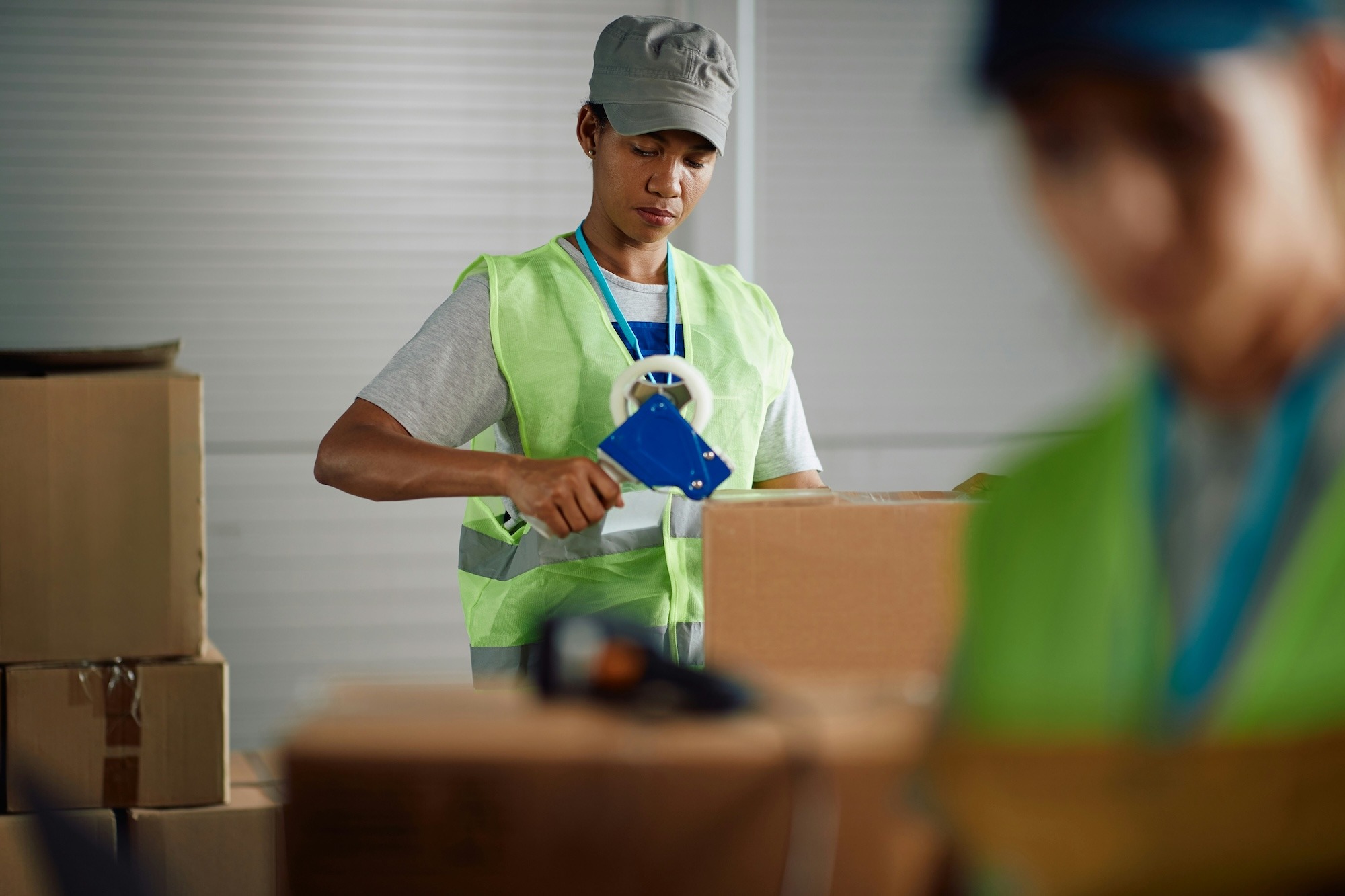 A 3PL warehouse worker packing online orders to prep for shipment