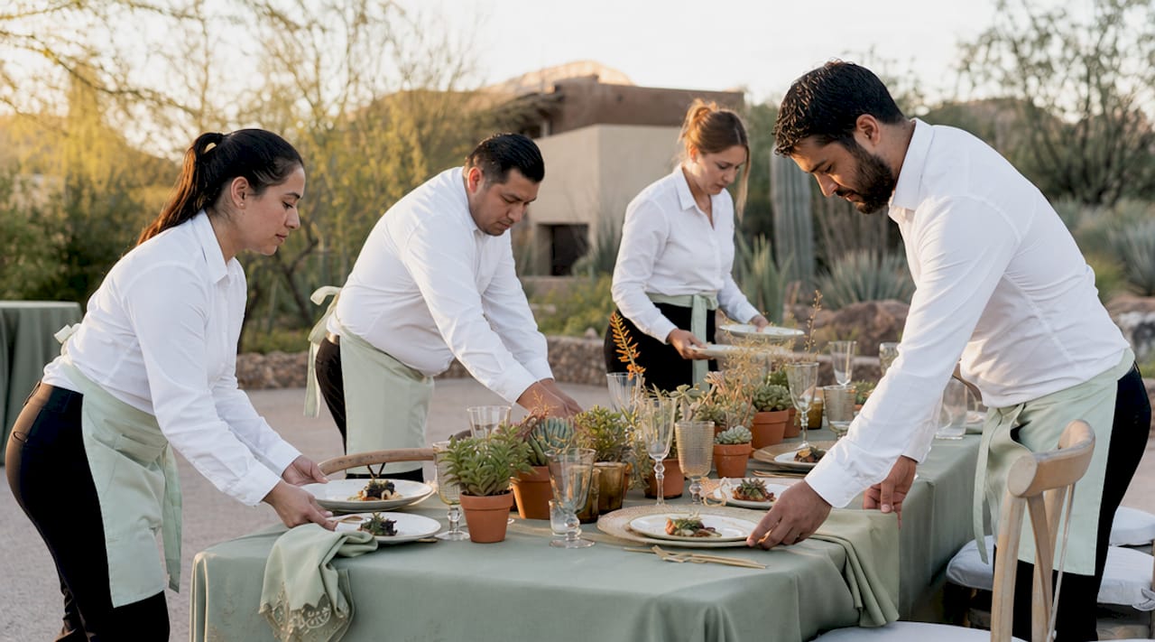 Boutique catering team setting food table