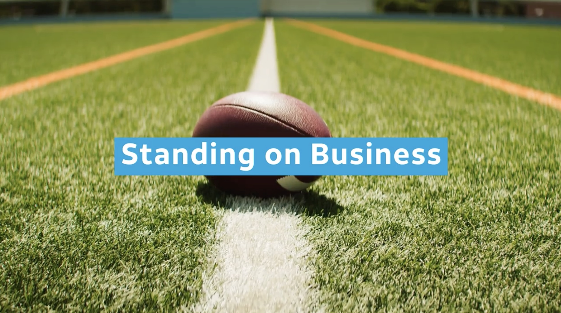 A football field with "Standing on Business" written overtop
