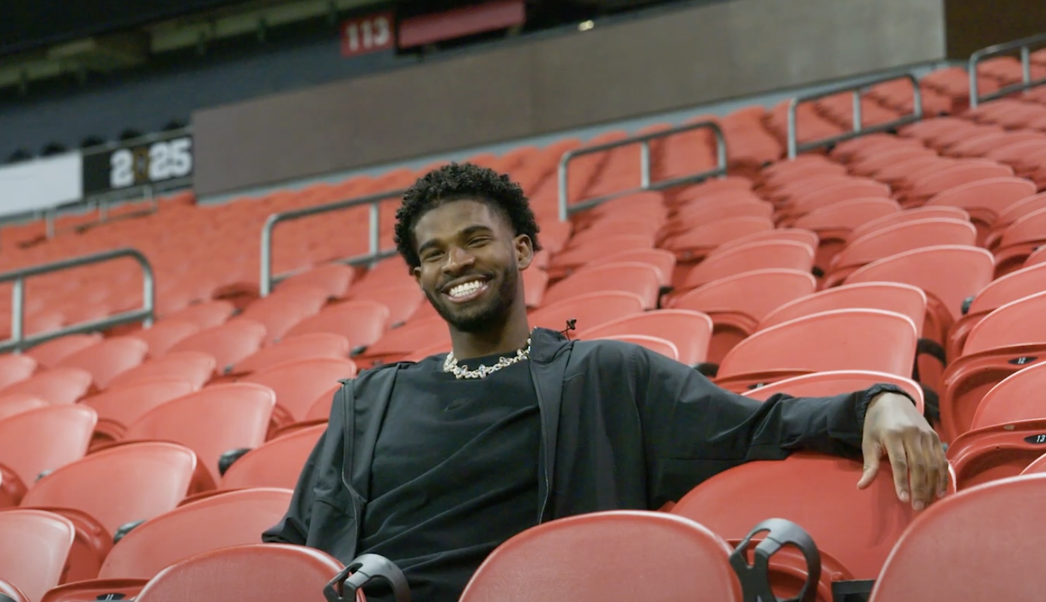 Shedeur Sanders sitting in stadium seats in Atlanta, Georgia