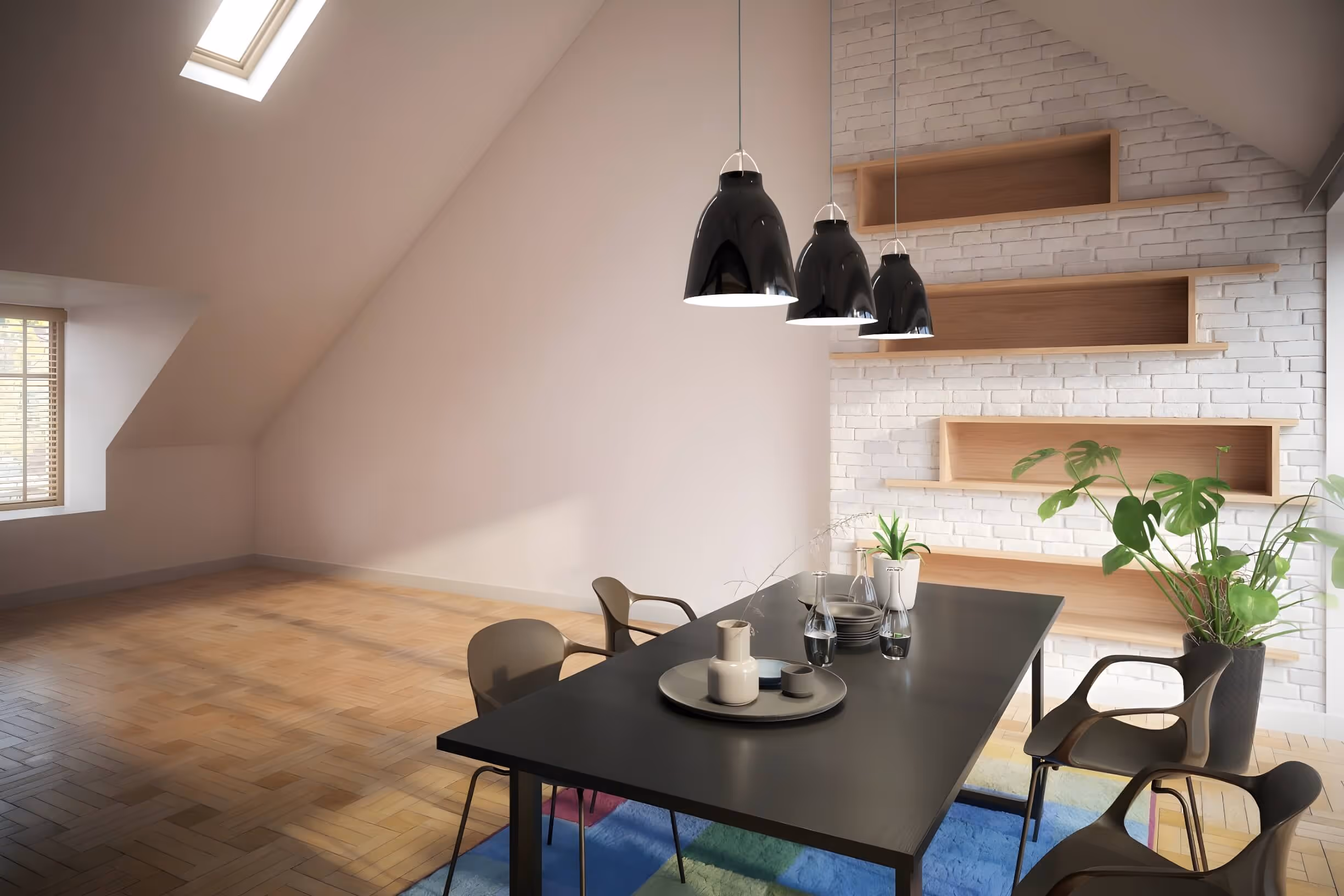 A modern dining area with a sloped ceiling and wooden floors. In the center, a black dining table is set with a round plate, a teacup, and a few glass bottles. Surrounding the table are four stylish chairs, two of which are visible. Above the table, three black pendant lights hang, illuminating the space. To the right, a textured white brick wall features wooden shelves holding small plants. A window on the left has wooden blinds, allowing natural light to enter the room, creating a bright and airy atmosphere. A colorful rug is partially visible under the table.