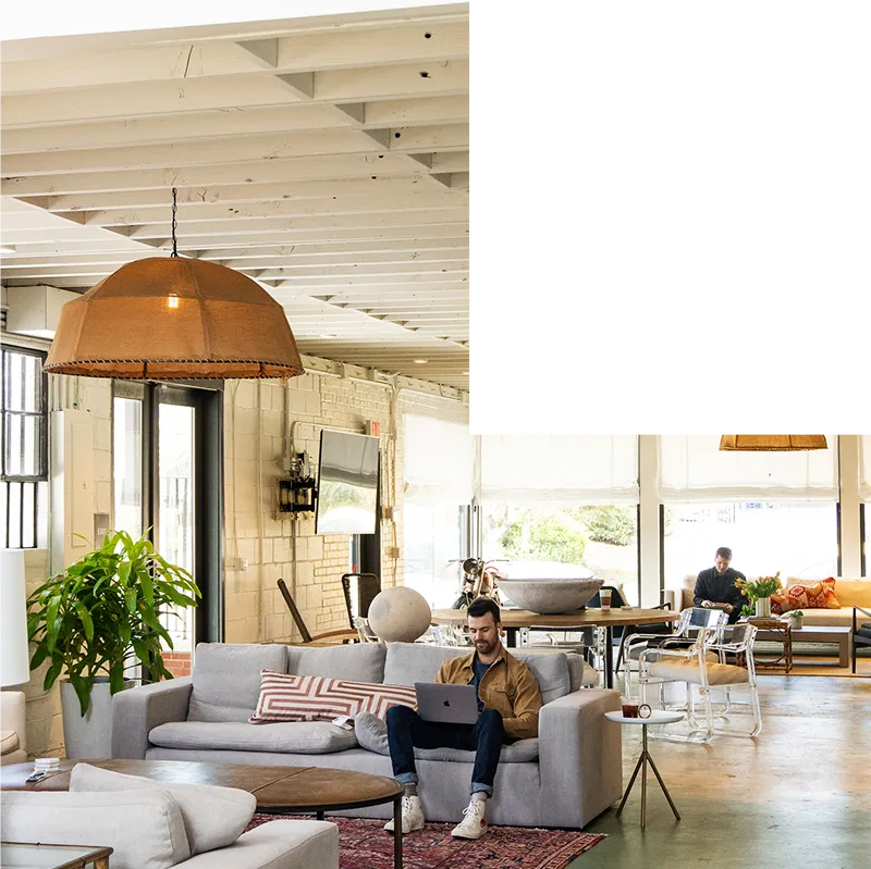 Man smiling while working on Macbook in Local's airy Atlanta HQ