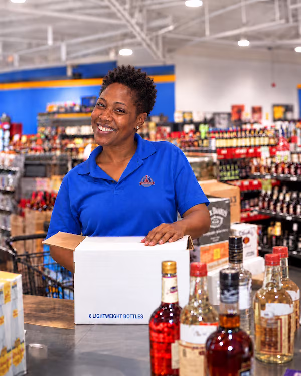 A smiling Liquor Depot team member at the register