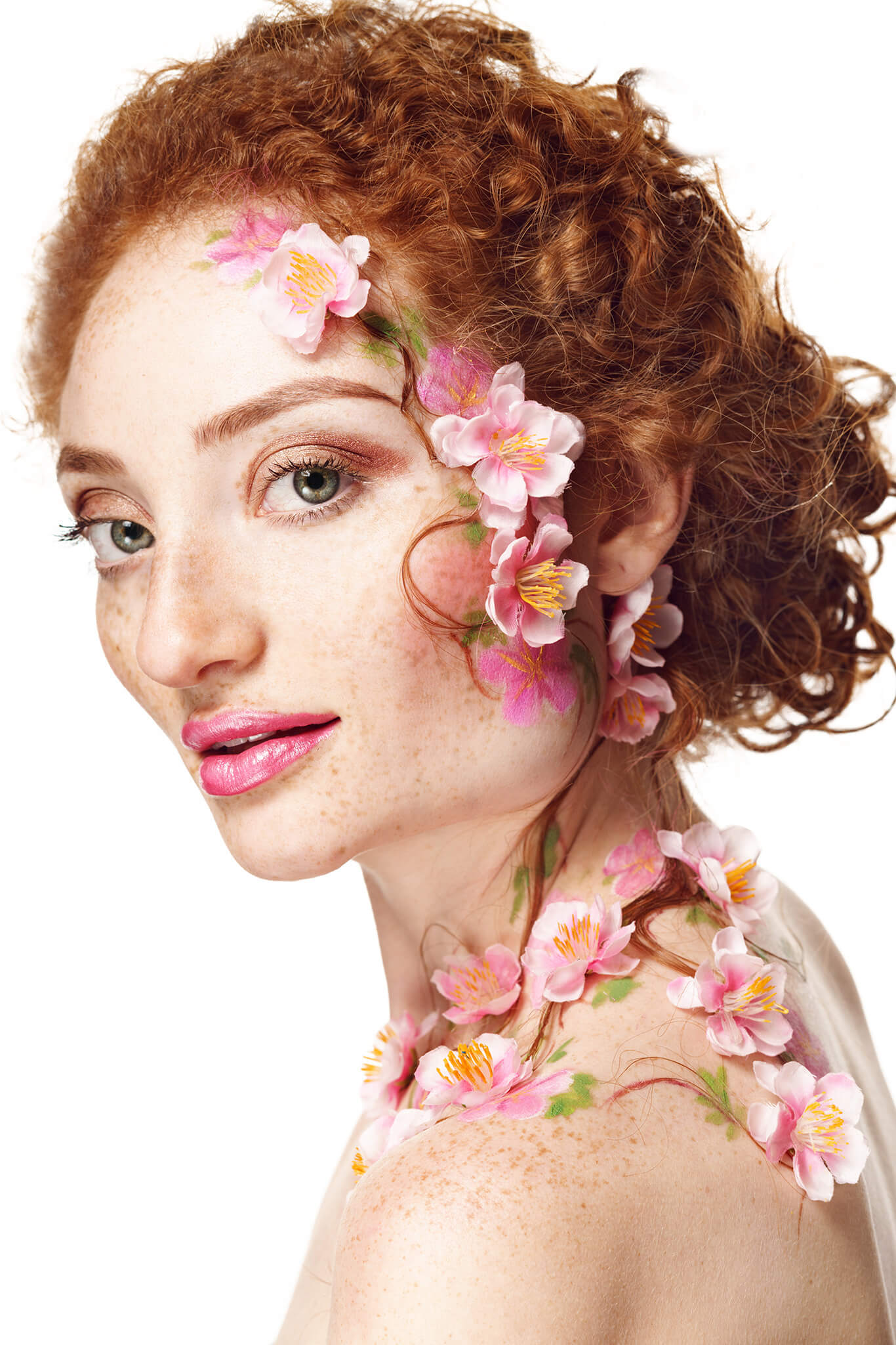 Pale, red headed woman with elegant pink and white flowers "growing" out of her skin. 