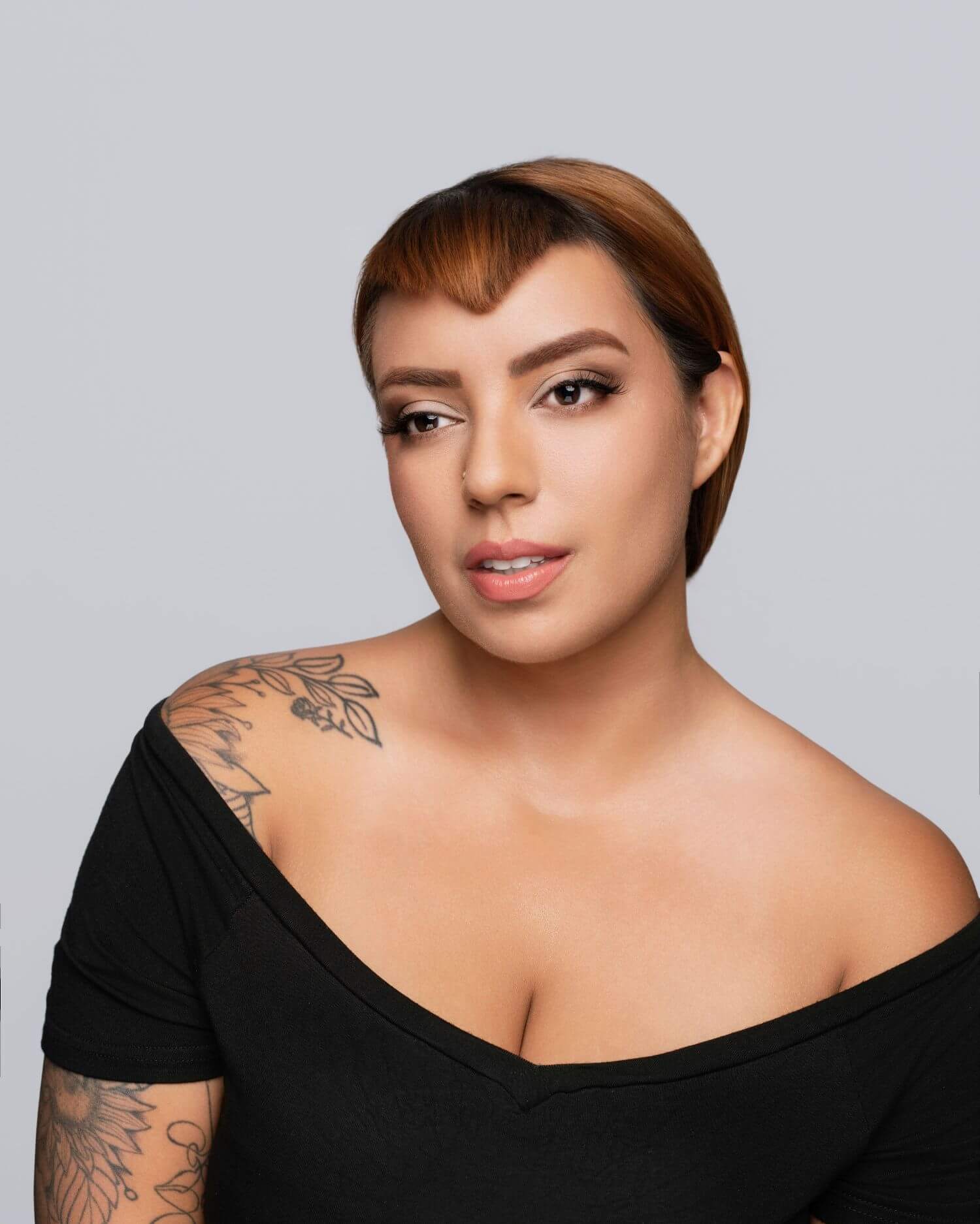 Young woman in open cut black shirt with beauty makeup done by OKOS Creations