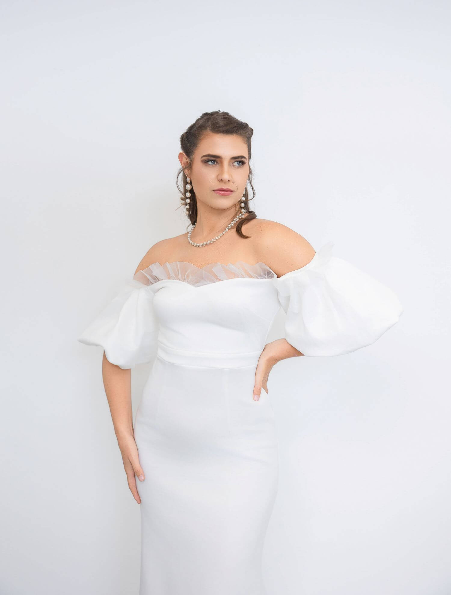 Young bride in wedding dress, with beautiful bridal makeup done by OKOS Creations.