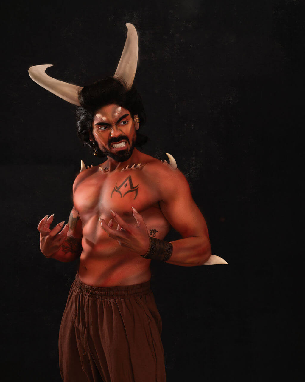 Jay posing in red demon makeup with prosthetic horns and bearing sharp fangs.