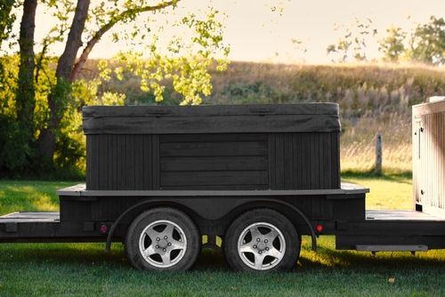 Monster hot tub on a deck, overlooking a garden.