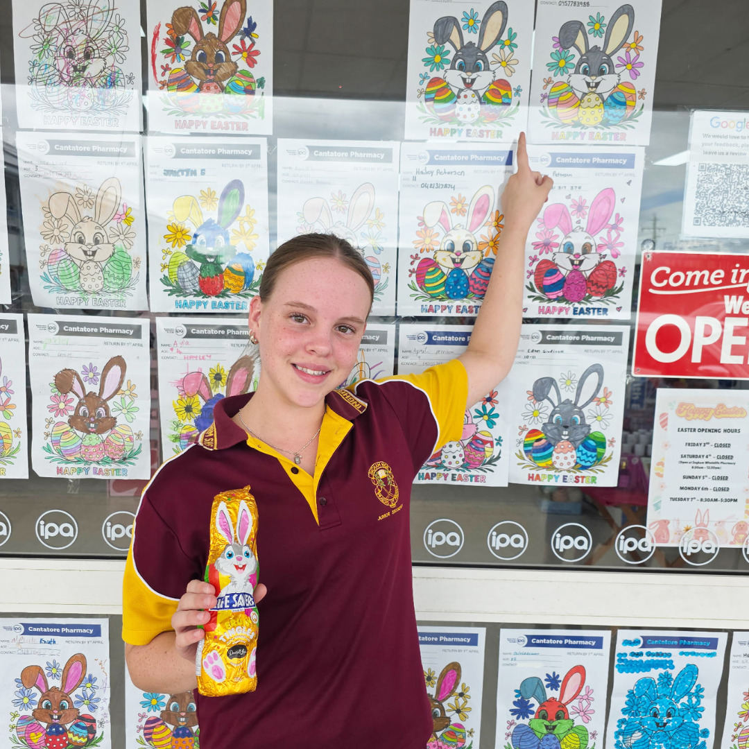 Amayah 10-12 year old winner, pointing out her artwork.